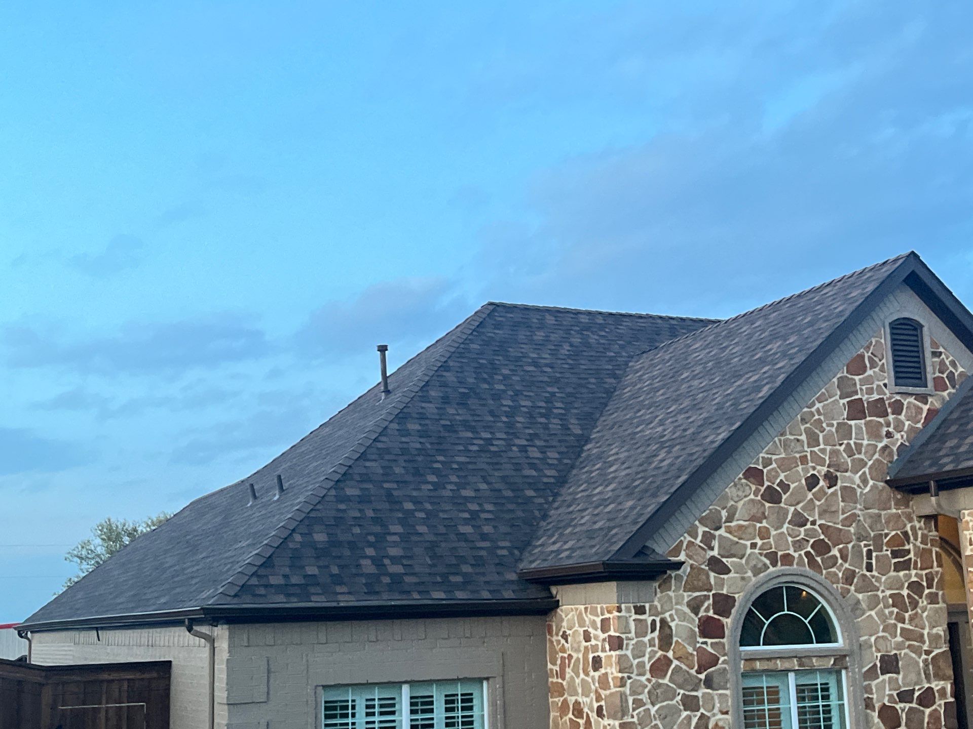 Cream brick/mixed stone with IKO Shadow Brown by Tejas Roofworks + Restoration
