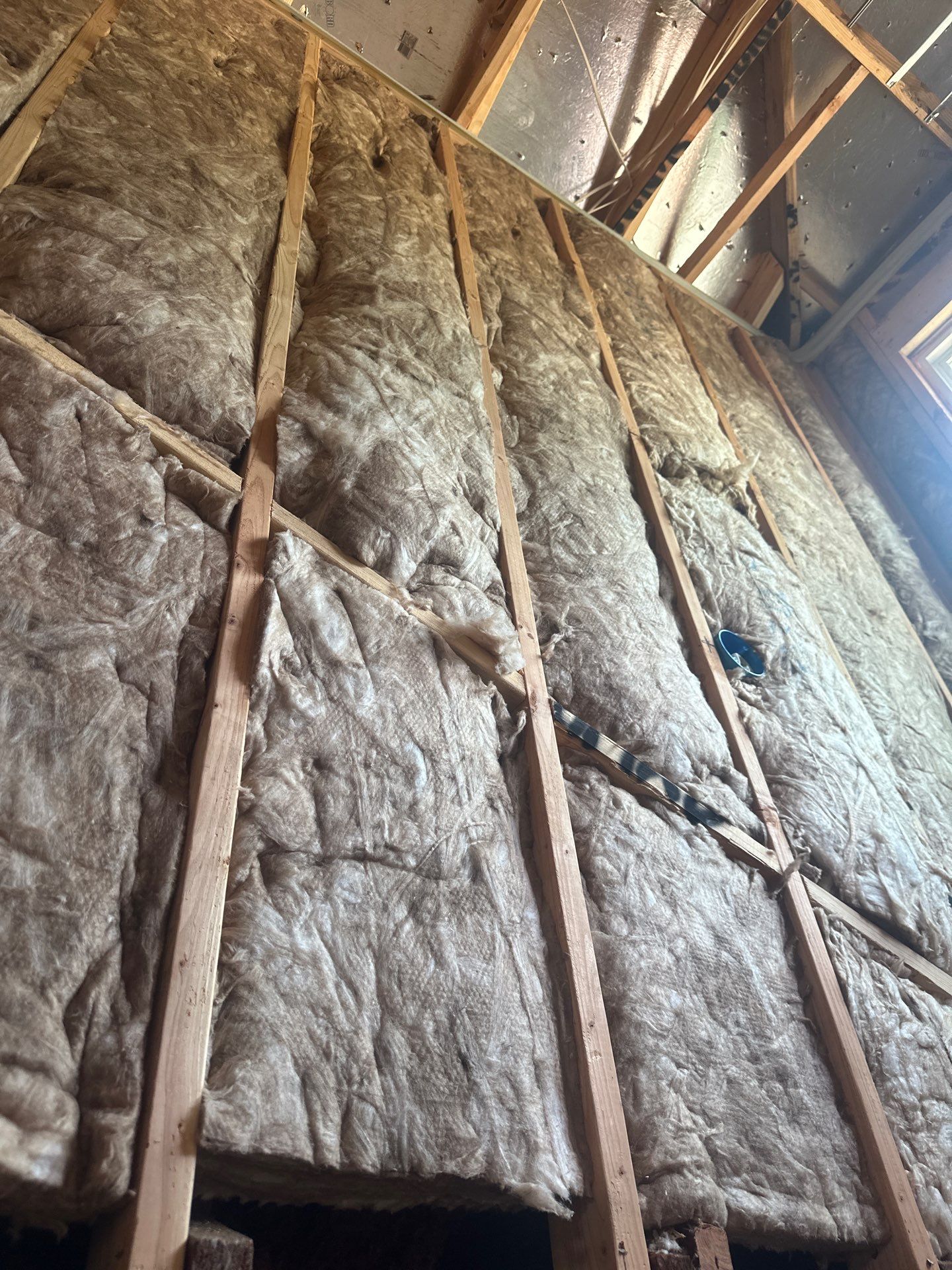Fiberglass batt install on a second story addition in Dallas by Apex Insulation Solutions