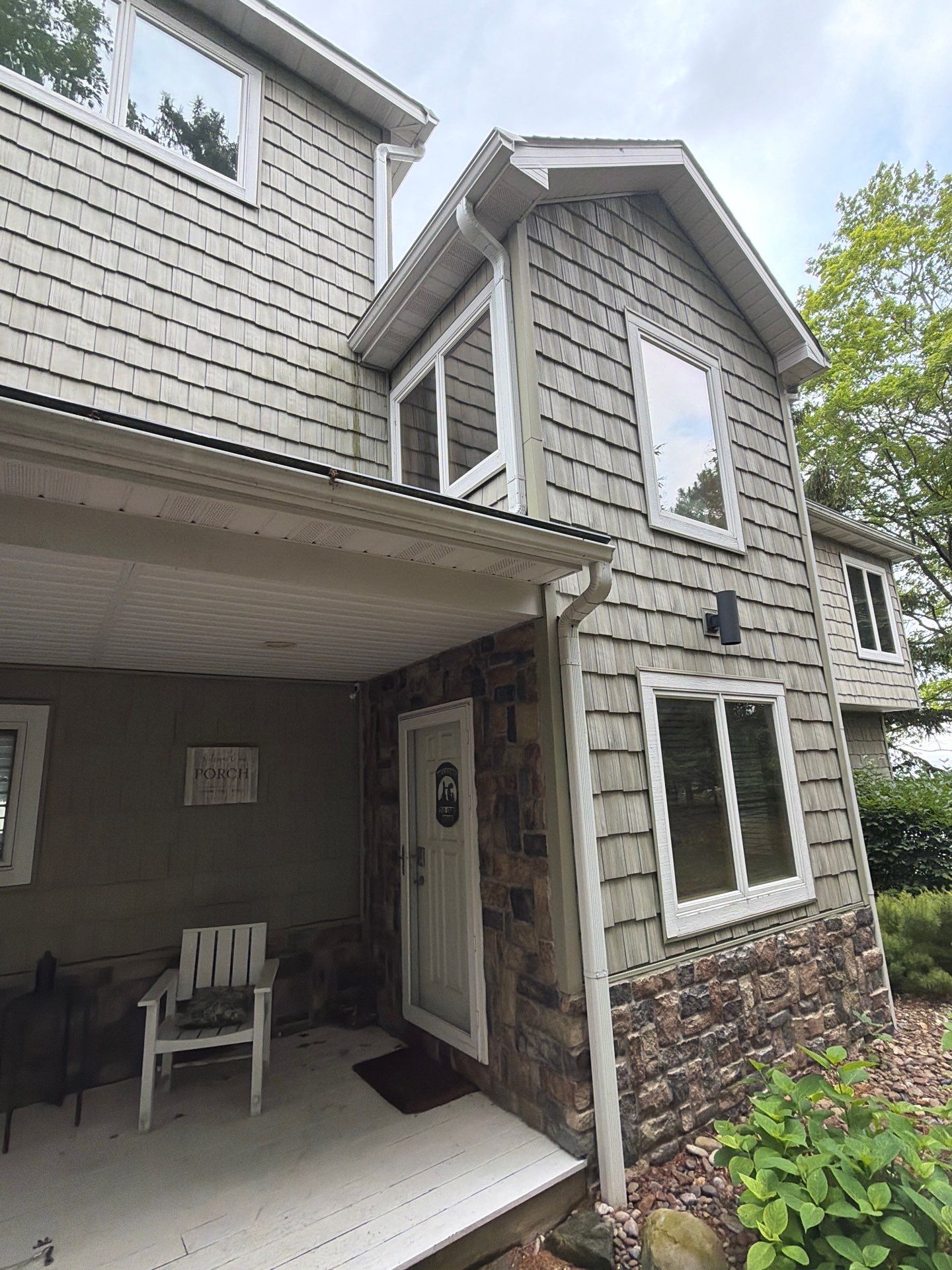 Gutter Helmet Protection System for Suttons Bay Home with Cedar Siding by Rainbow Seamless Systems