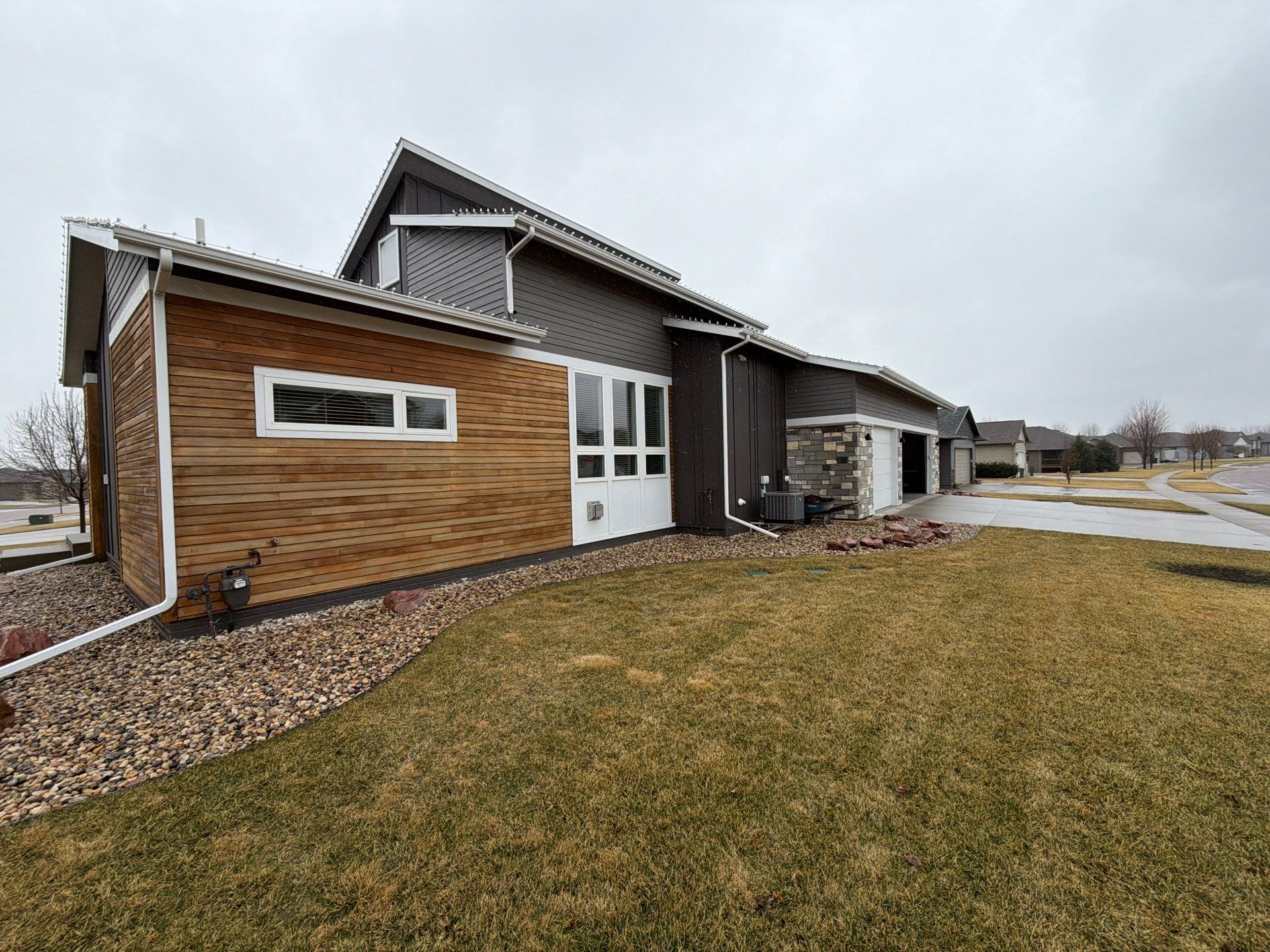 Modern Exterior Transformation Featuring Dark Board and Batten Siding in Sioux Falls by Select Painting, Coatings & Garage Cabinets