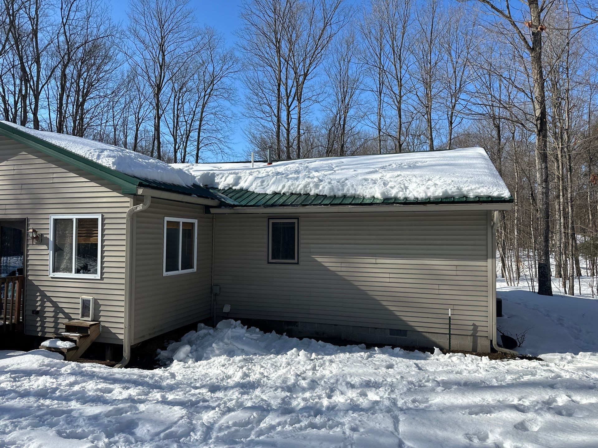 Residential Ice Dam Removal in Bellaire, MI by Rainbow Seamless Systems