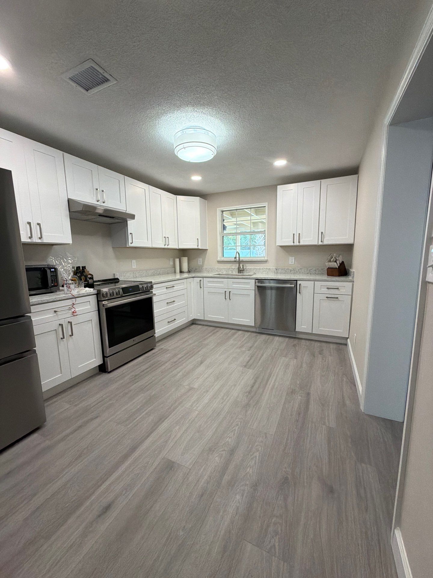 Comprehensive Home Remodel featuring Bright Modern Kitchen by Acies Renovations