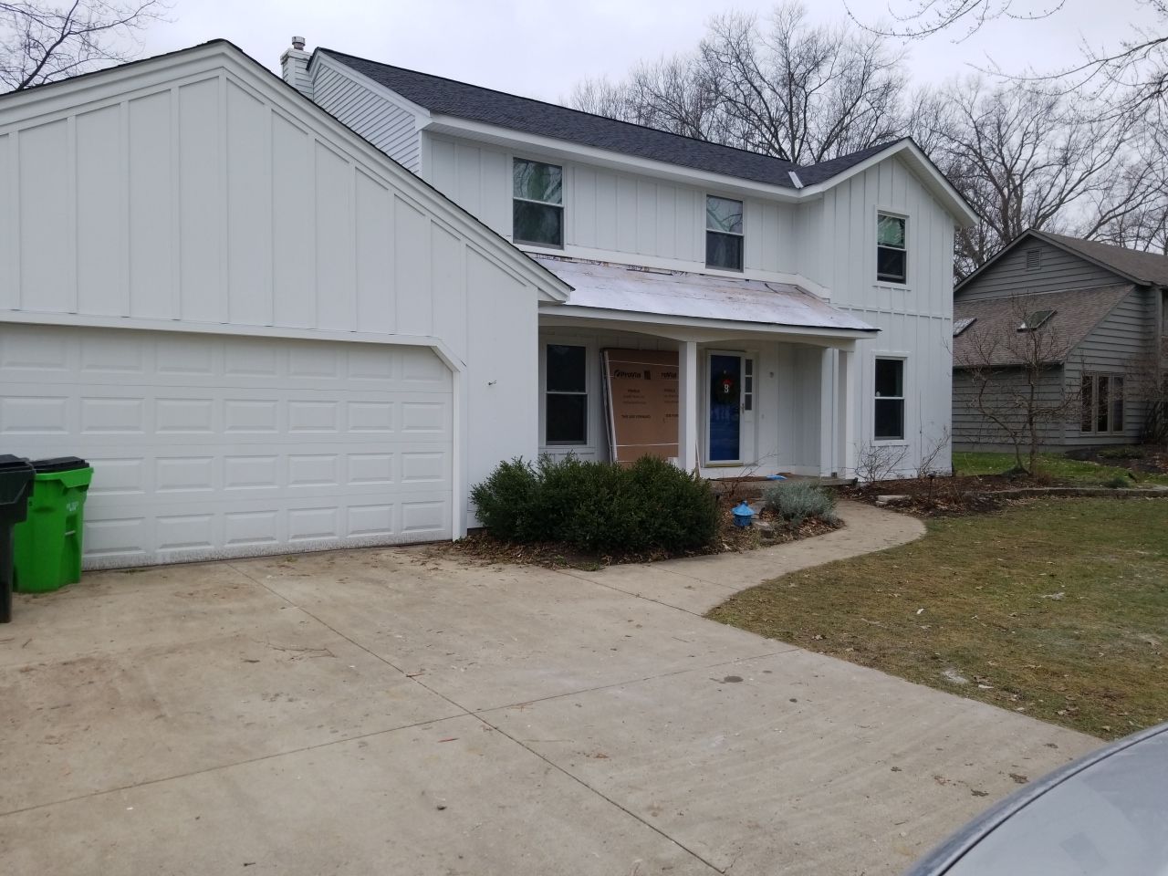 James Hardie Siding  using James Hardie Board and Batten, White by Absolute Roofing and Construction