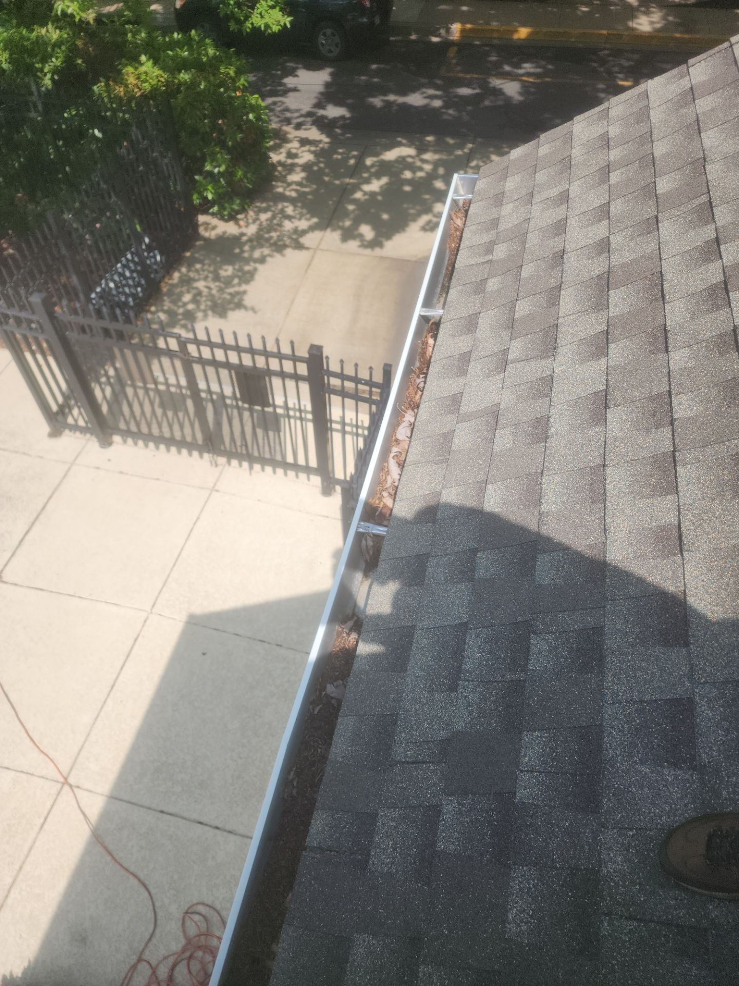 HOA gutter cleaning in Winchester, VA,before  photo showing full gutters.