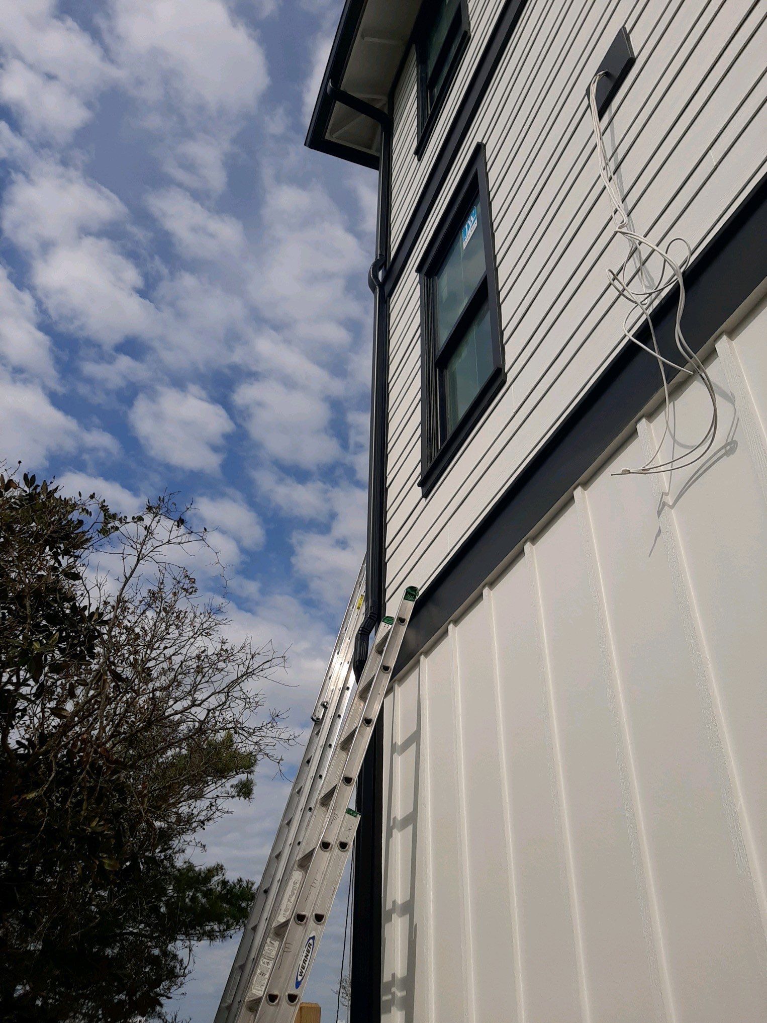 Seamless Gutter Installation Using Black Half Round Seamless Gutters by Gutter Professors