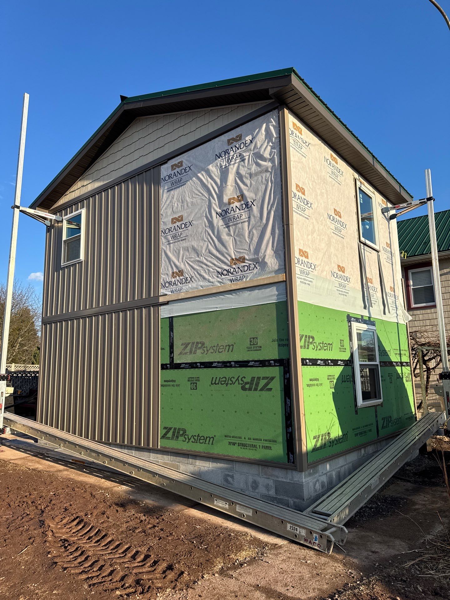 Multi-Story Residential Addition Featuring Textured Metal Siding in Millersburg by Esh Builders
