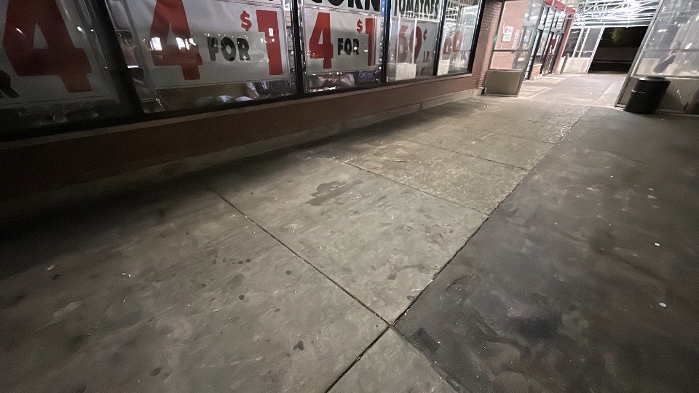 Concrete sidewalk cleaning and degreasing by Northern Power Washing LLC.
