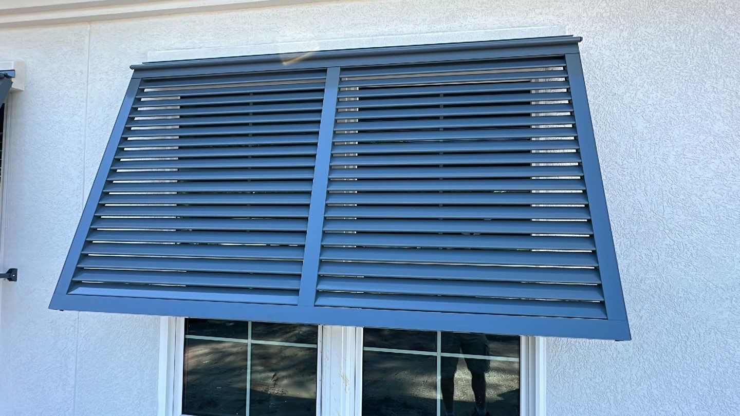 Bahama Shutters in Blue Grey  by Smart Guard Shutters