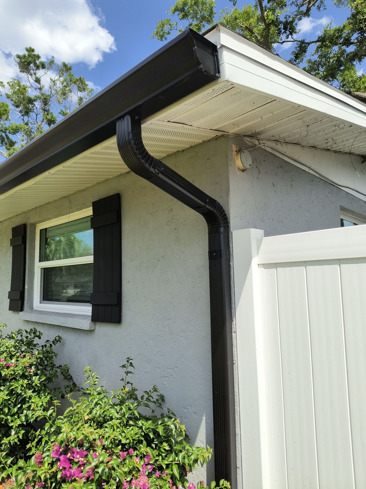 Black Seamless Gutters using 7 inch seamless gutters & New White Soffit in Sarasota FL by Gutter Professors