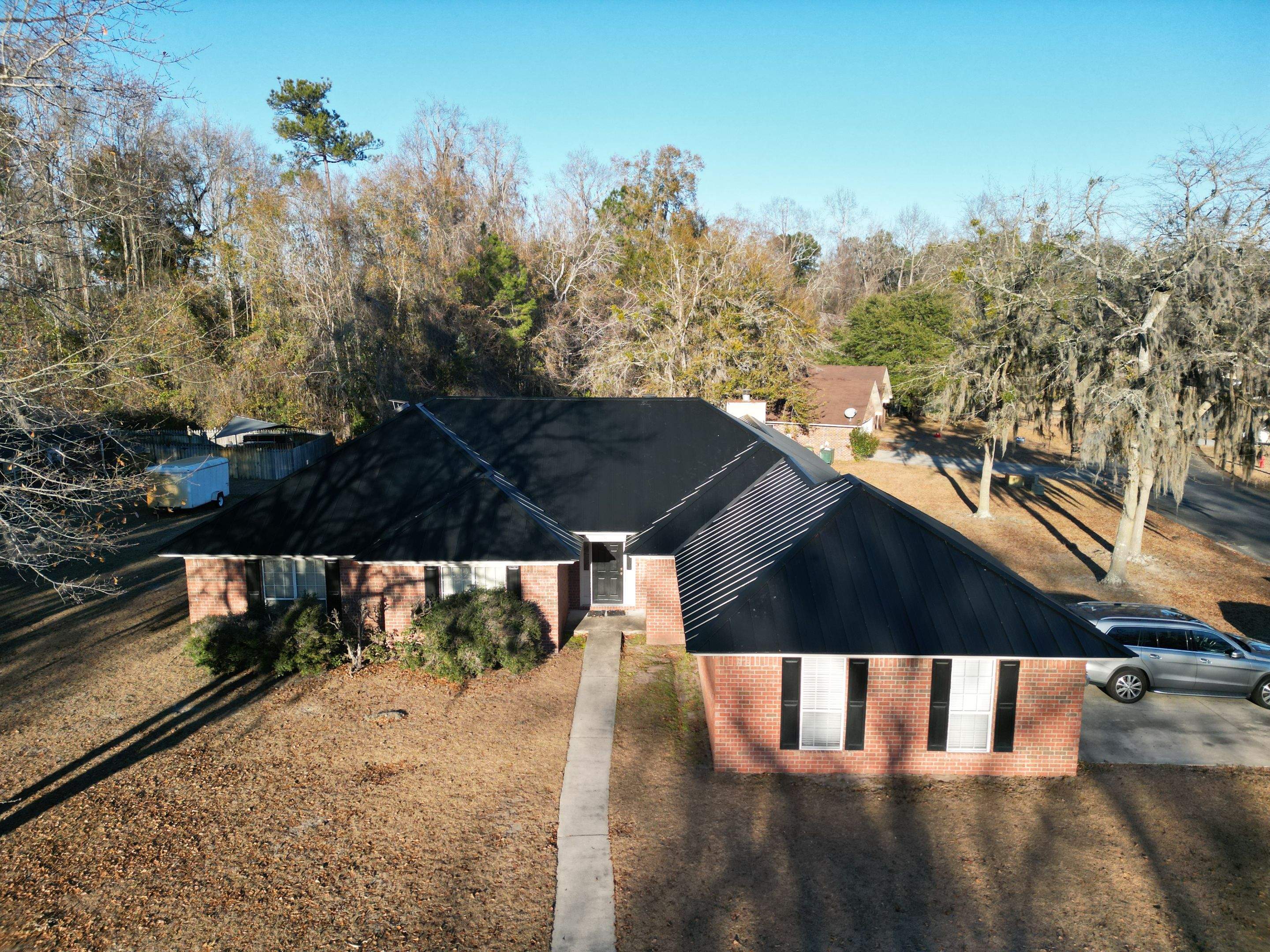 Residential Roofing Installation using Benton 26Ga 1inc Snapcock Metal Roof KYNAR Matte Black by Talya Roofing