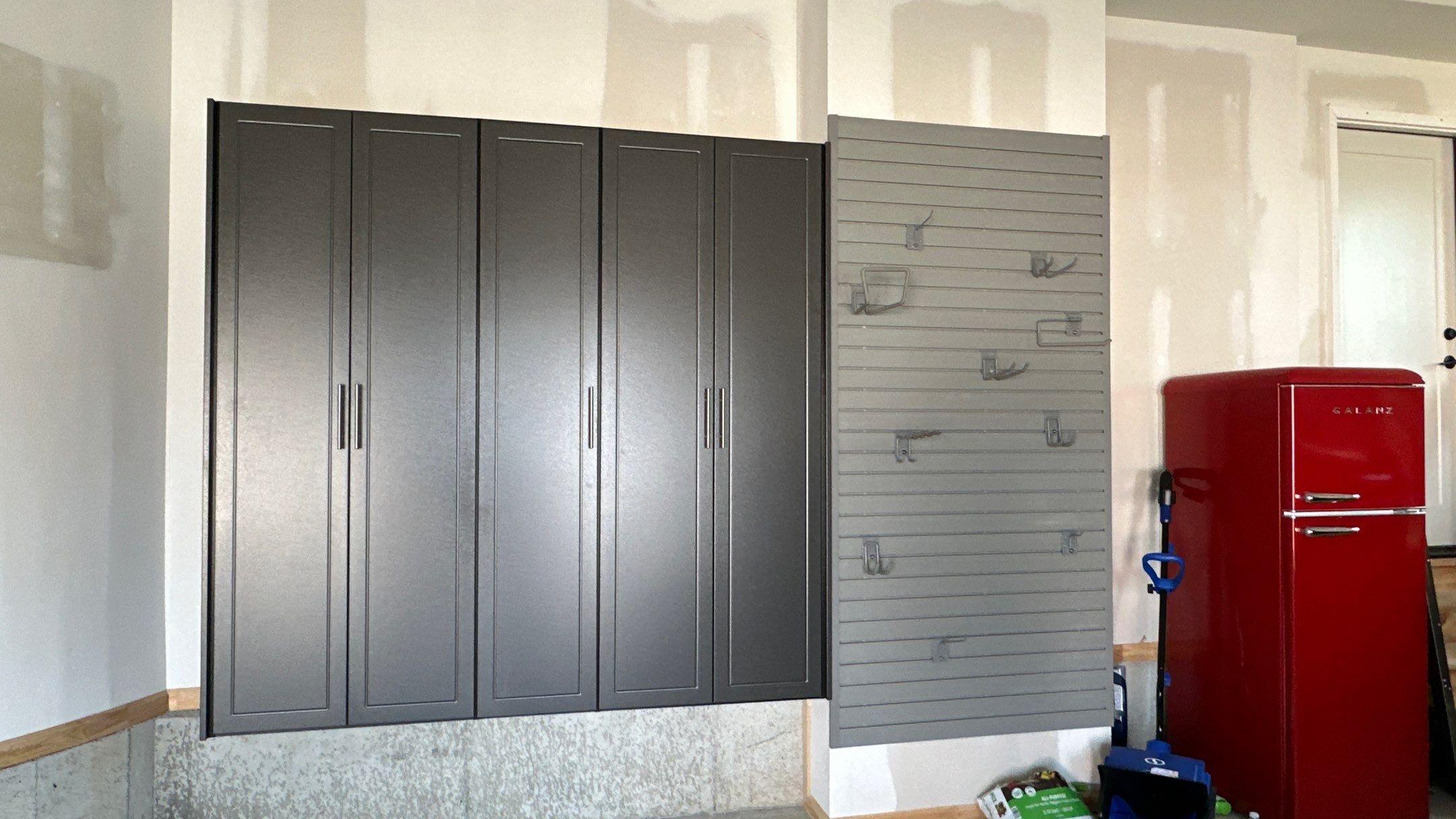 Megan J. added cabinets and slotwall to her garage. Plus a New Floor by Banner Garage