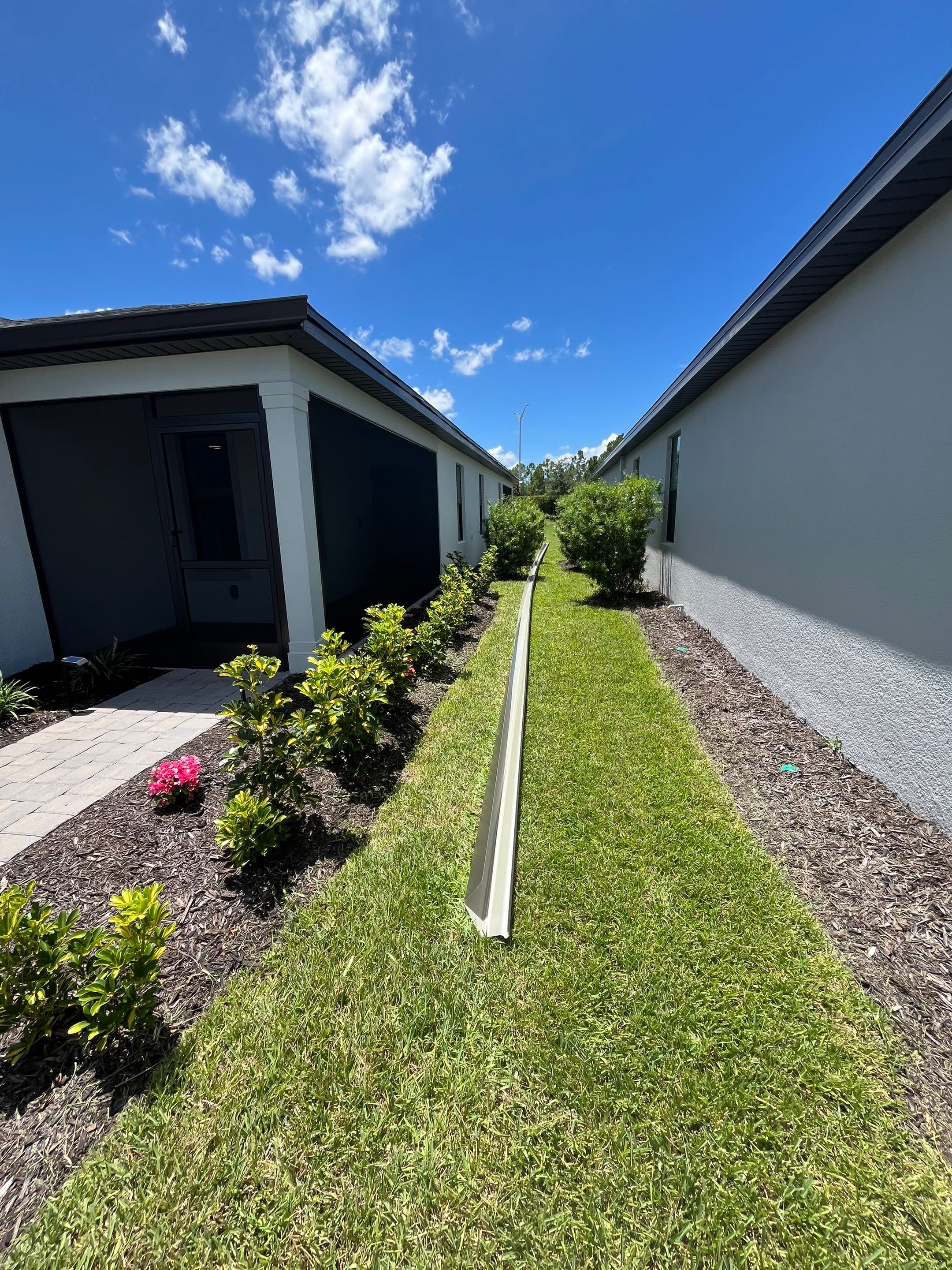 Dark Bronze Gutters and White Downspouts in Sarasota FL by Gutter Professors