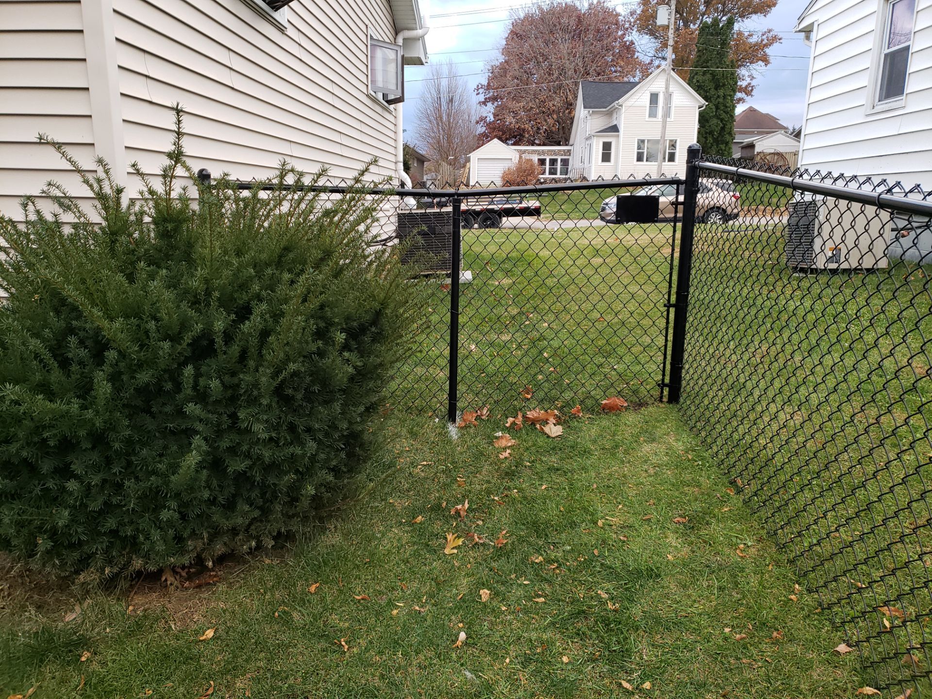 Residential Black Vinyl-Coated Chain Link Fence in Grundy Center by Perfect Picket Fence and Stain