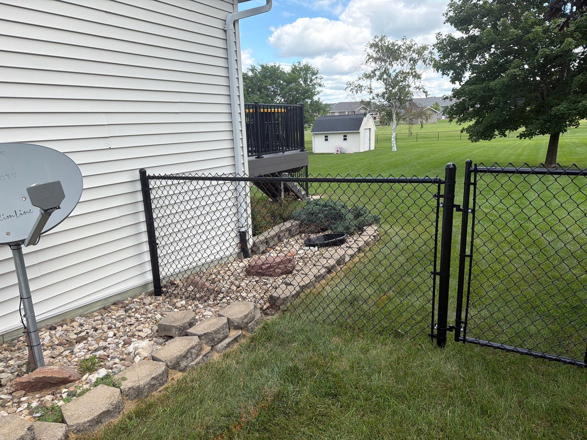 Black Vinyl-Coated Chain Link Fence Installation in Fairbank by Perfect Picket Fence and Stain