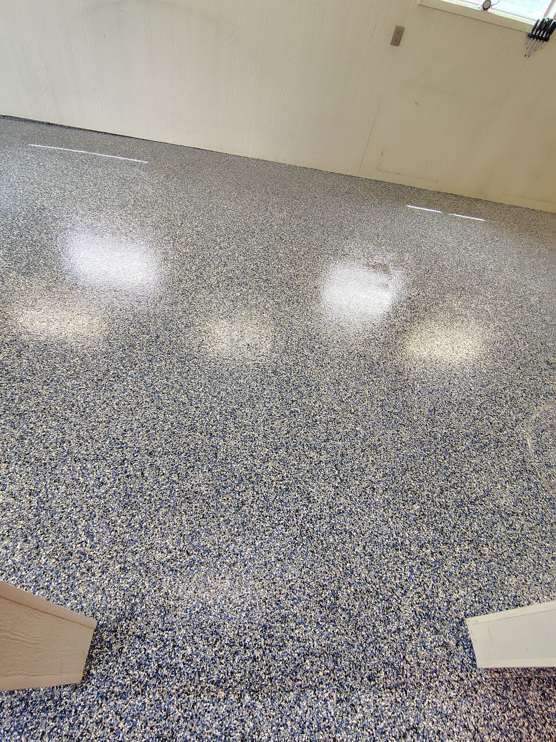 Custom Grey Flake Epoxy Garage Floor Installation in Remsen by Select Painting, Coatings & Garage Cabinets