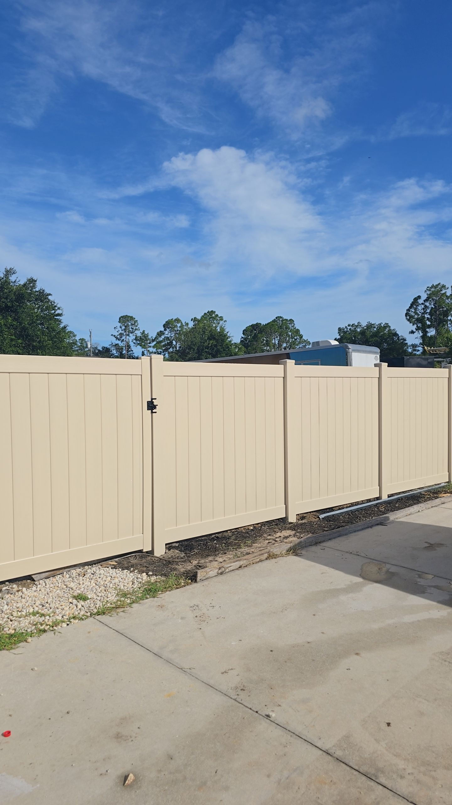 Tan Vinyl Privacy Fence and Gate Installation in North Port by True Fence LLC