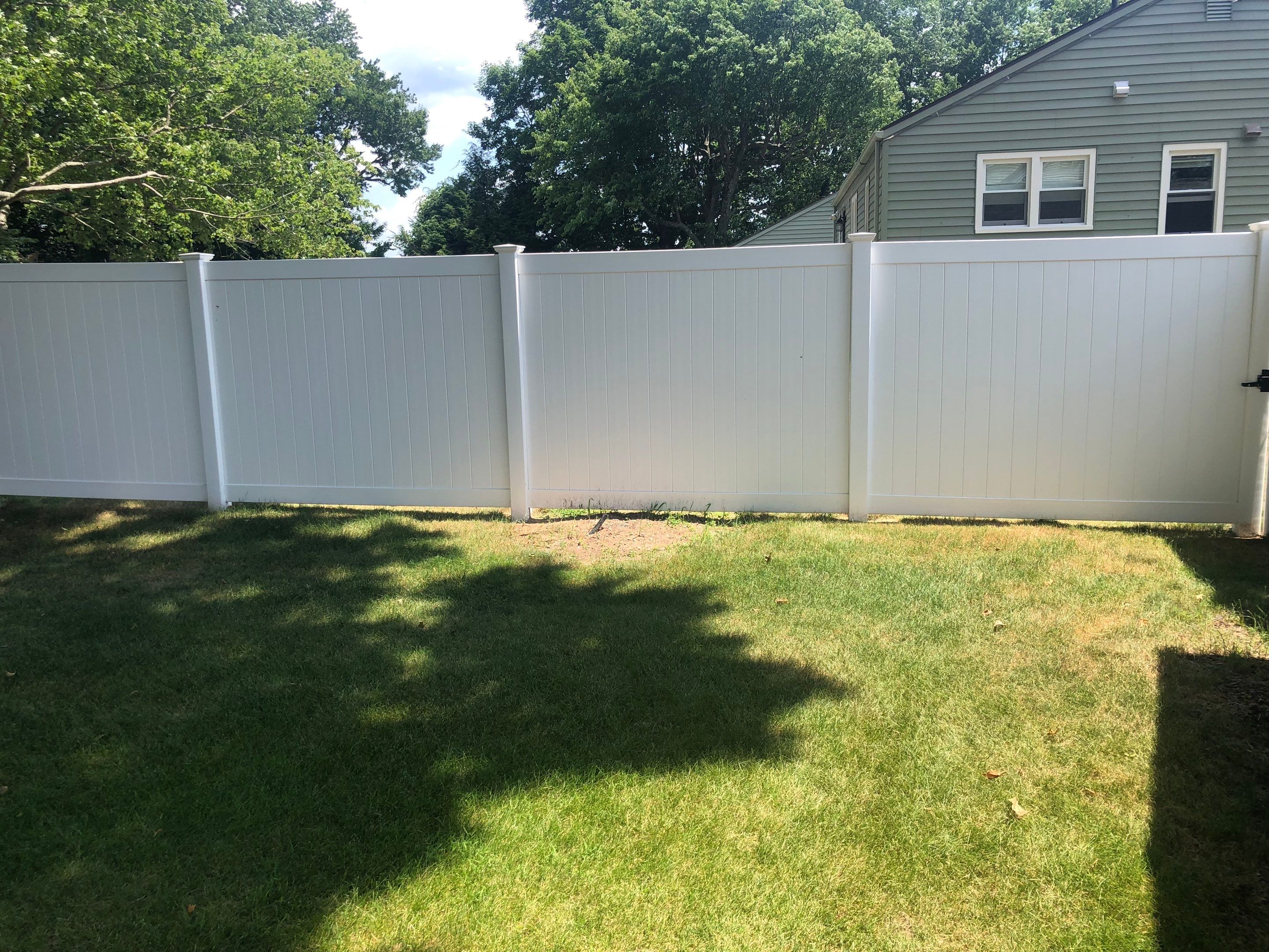 New Vinyl Privacy Fence with matching Gate in white. by DiGiorgi Roofing and Siding Inc