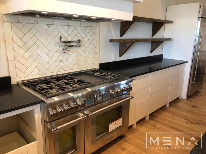 Kitchen, outdoor kitchen and pool brick floor installation by Mena stone surfaces