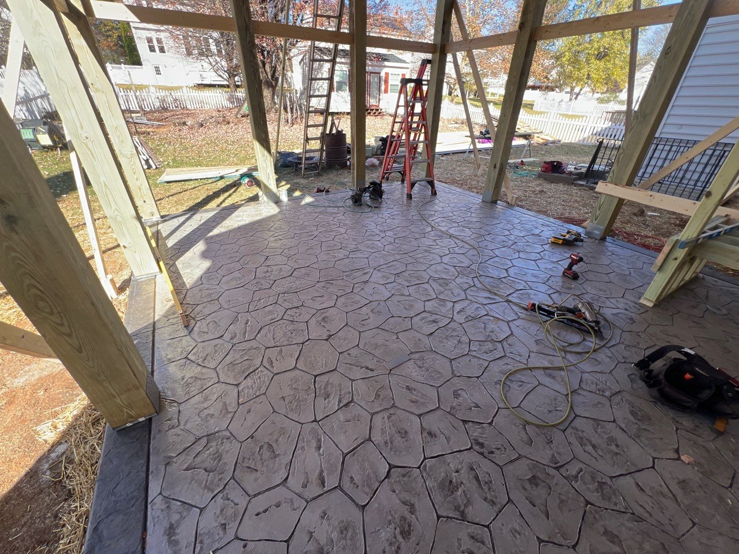 Custom Screened-In Porch with Stamped Concrete Patio in Warrenton by Jakari Restoration & Construction LLC