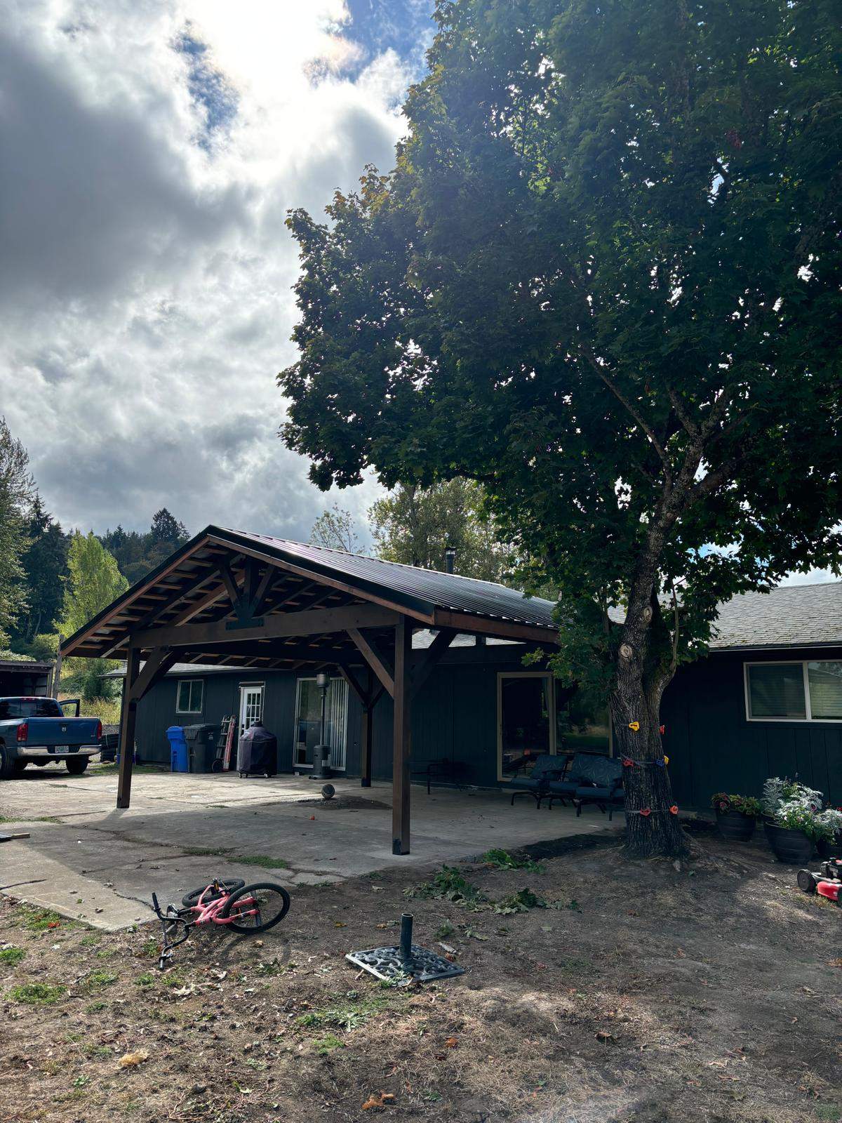Custom Timber Frame Patio Cover with Black Metal Roof by American Made Construction