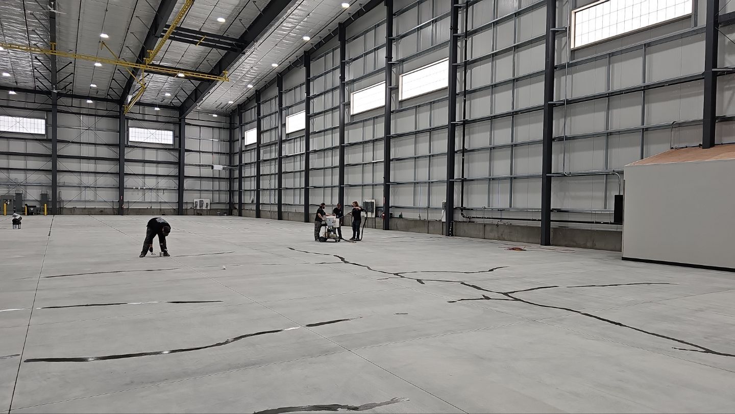 Airplane Hanger using Light Grey Commercial Penntek Epoxy by Croc Coatings, LLC