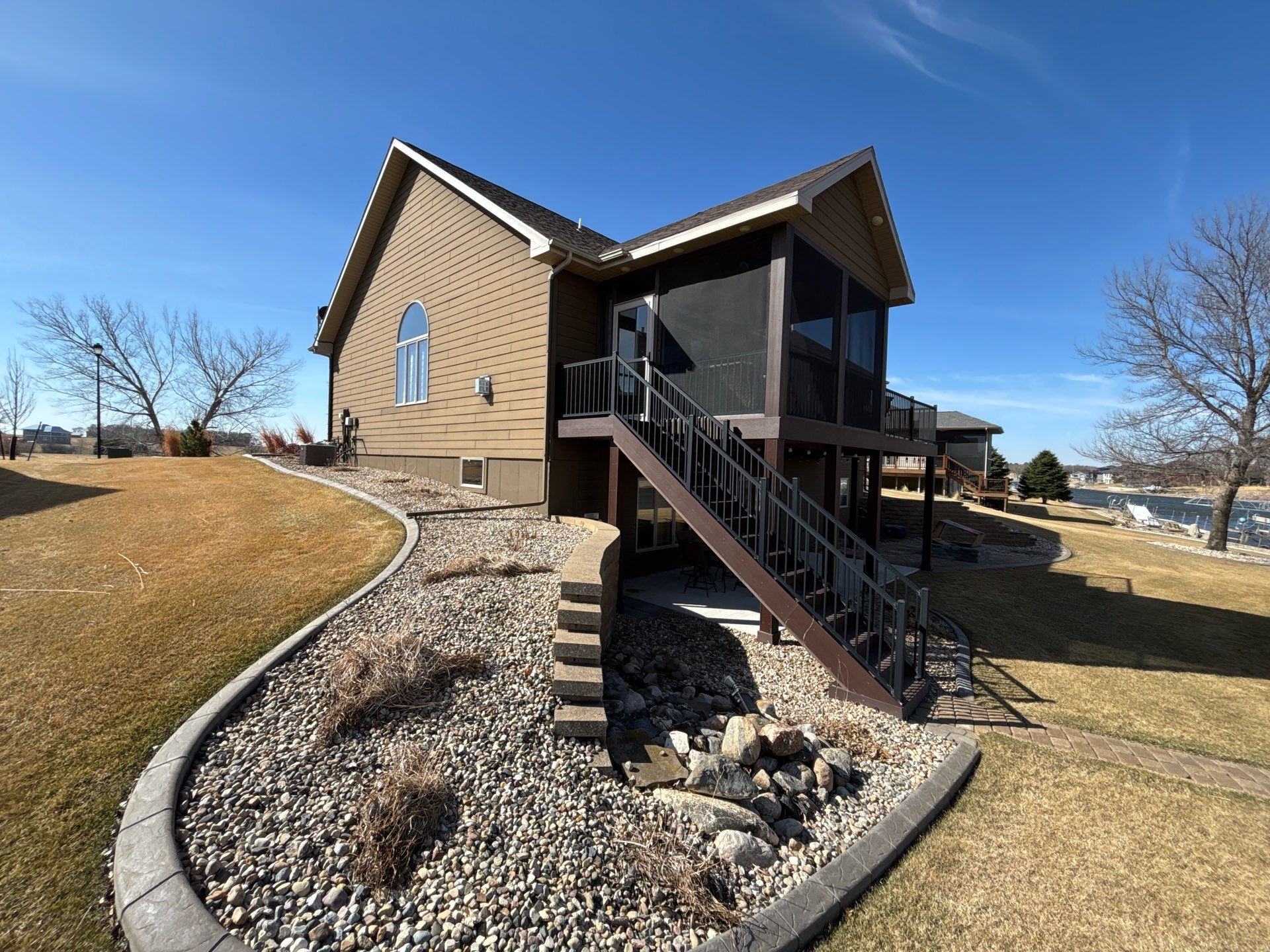 Full Exterior Renovation with Stone Veneer and Composite Decking by Select Painting, Coatings & Garage Cabinets