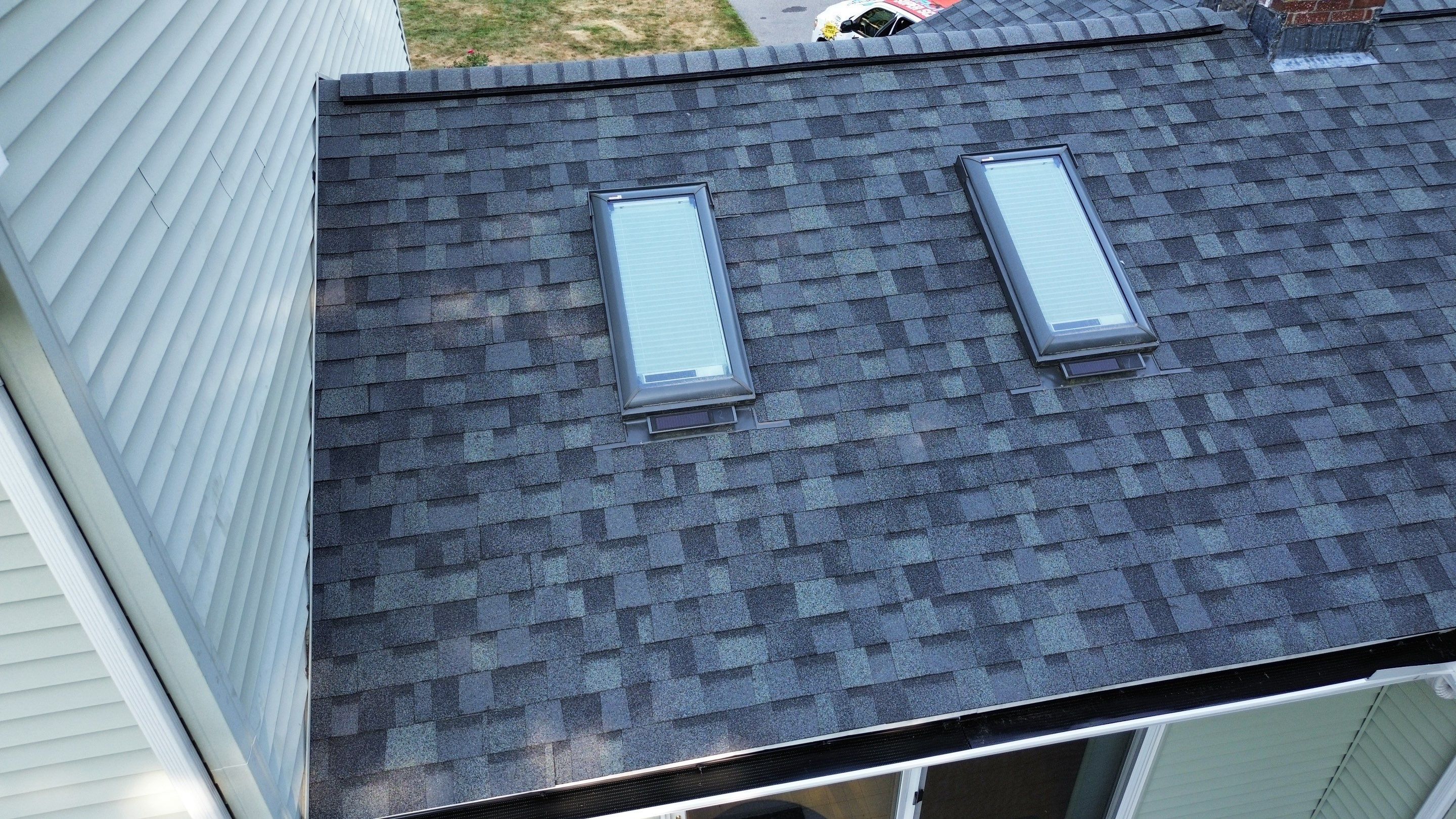 Complete Roof Replacement with Chimney Flashing, Gutter Guard System, and Vinyl Siding Repairs by Mighty Dog Roofing of Greater Middlesex County