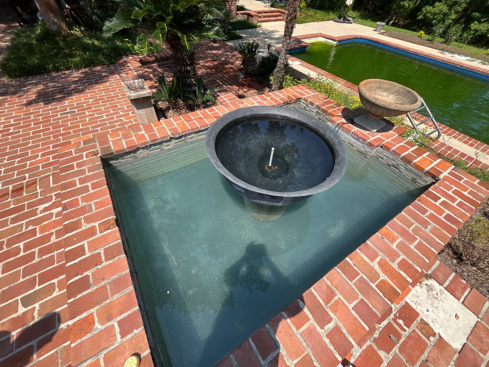 Pool Cleaning using Pool Cleaner by College Bros Outdoor services