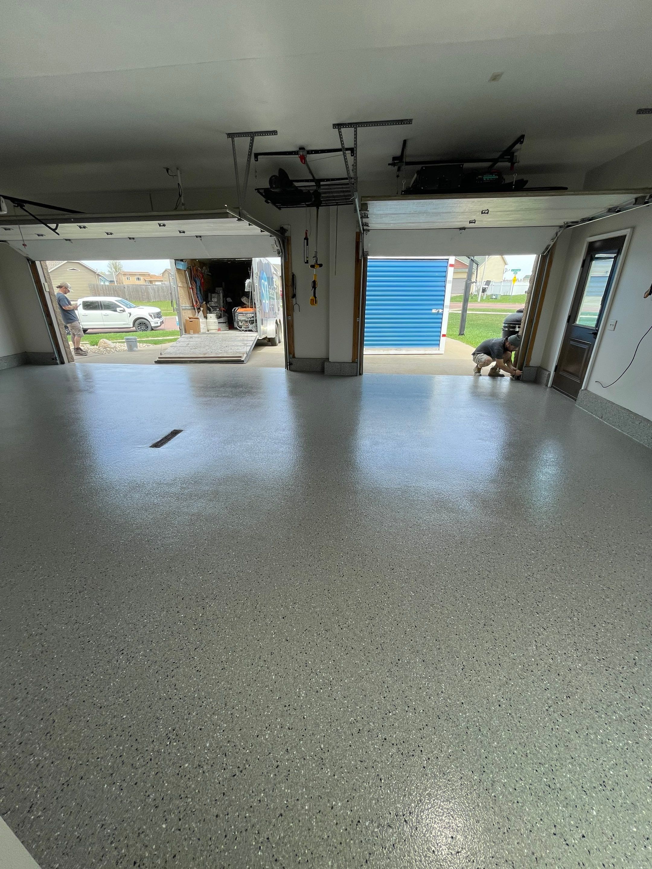 Residential Garage Floor Coating with Grey Speckled Epoxy Finish by Select Painting, Coatings & Garage Cabinets
