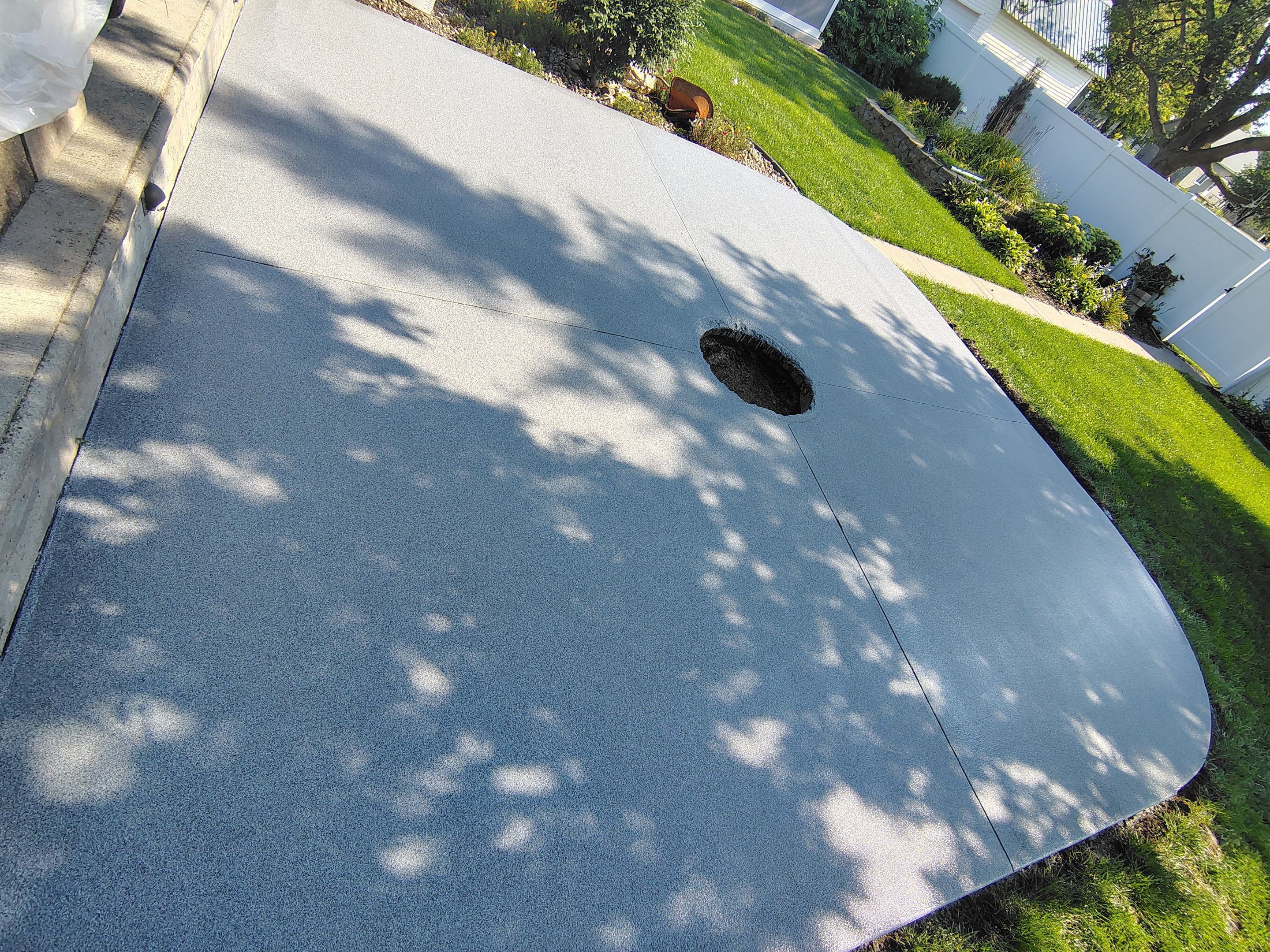 Custom Garage Floor Coating and Backyard Patio Refinishing in Tyndall by Select Painting, Coatings & Garage Cabinets