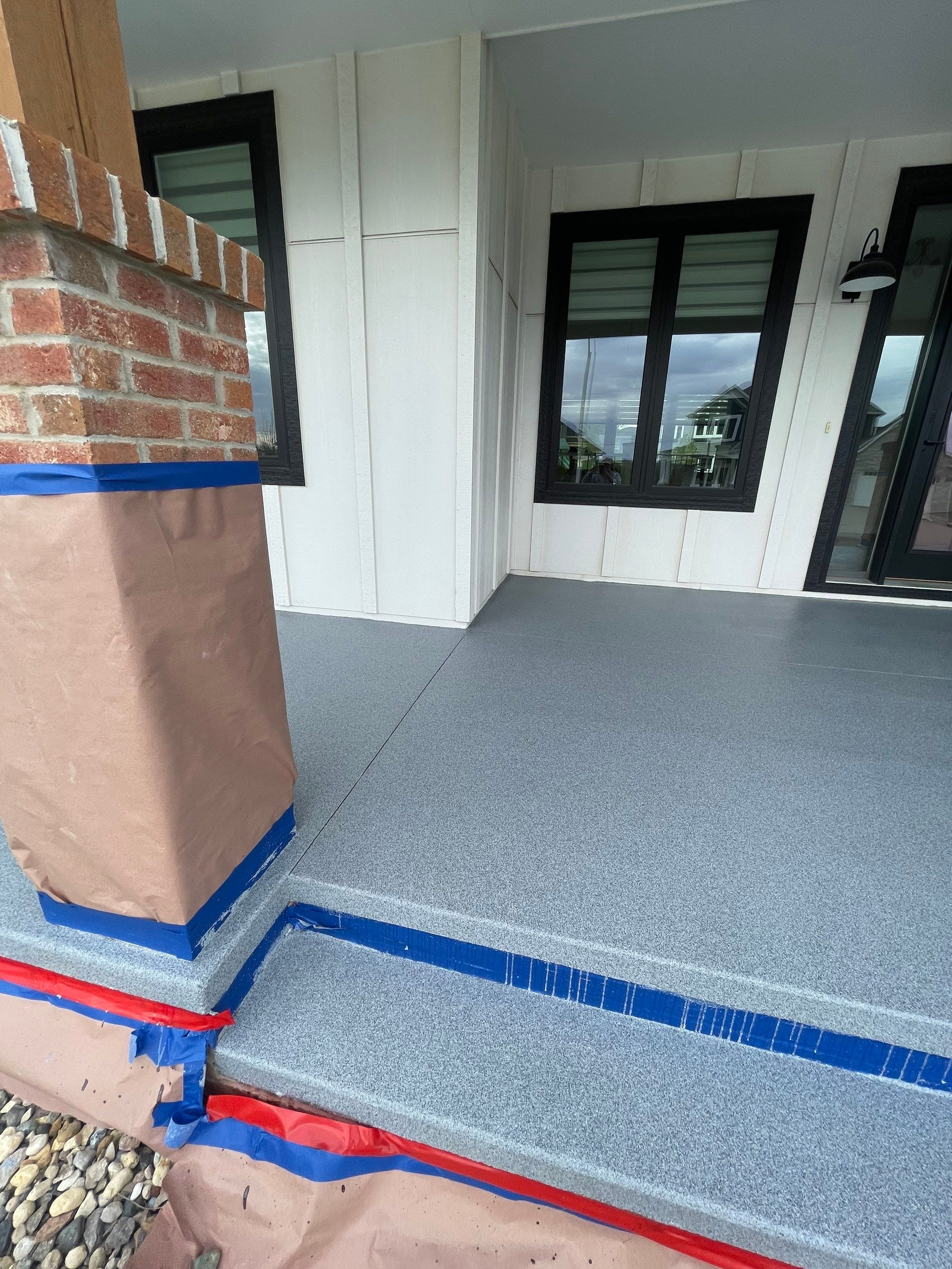 Grey Speckled Concrete Porch Coating for Sioux Falls Home by Select Painting, Coatings & Garage Cabinets