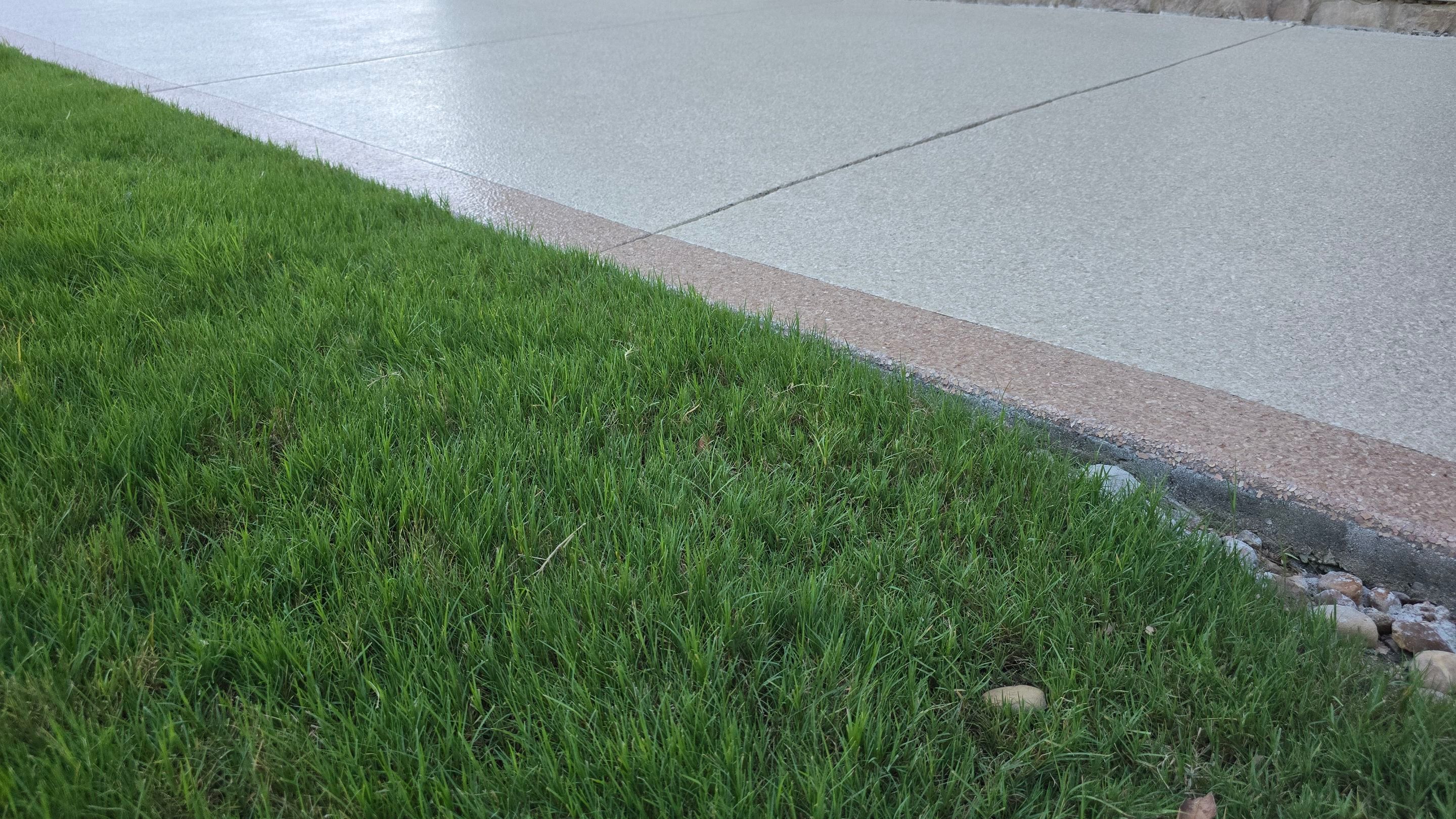 Driveway and sidewalk using Feldspar with the border done in Spilite by Elite Floor Solutions
