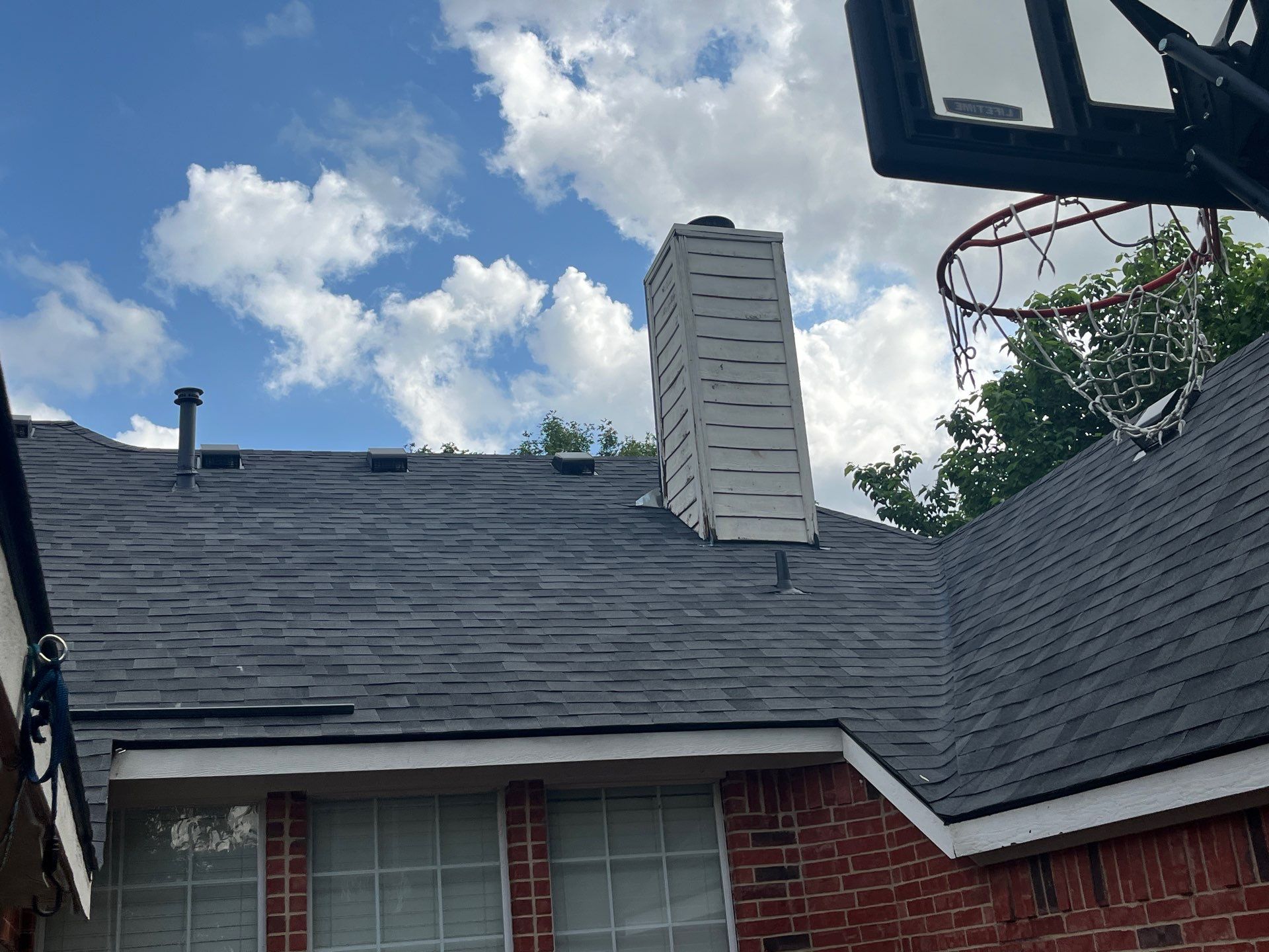 Red brick with Malarkey Midnight Black  by Tejas Roofworks + Restoration