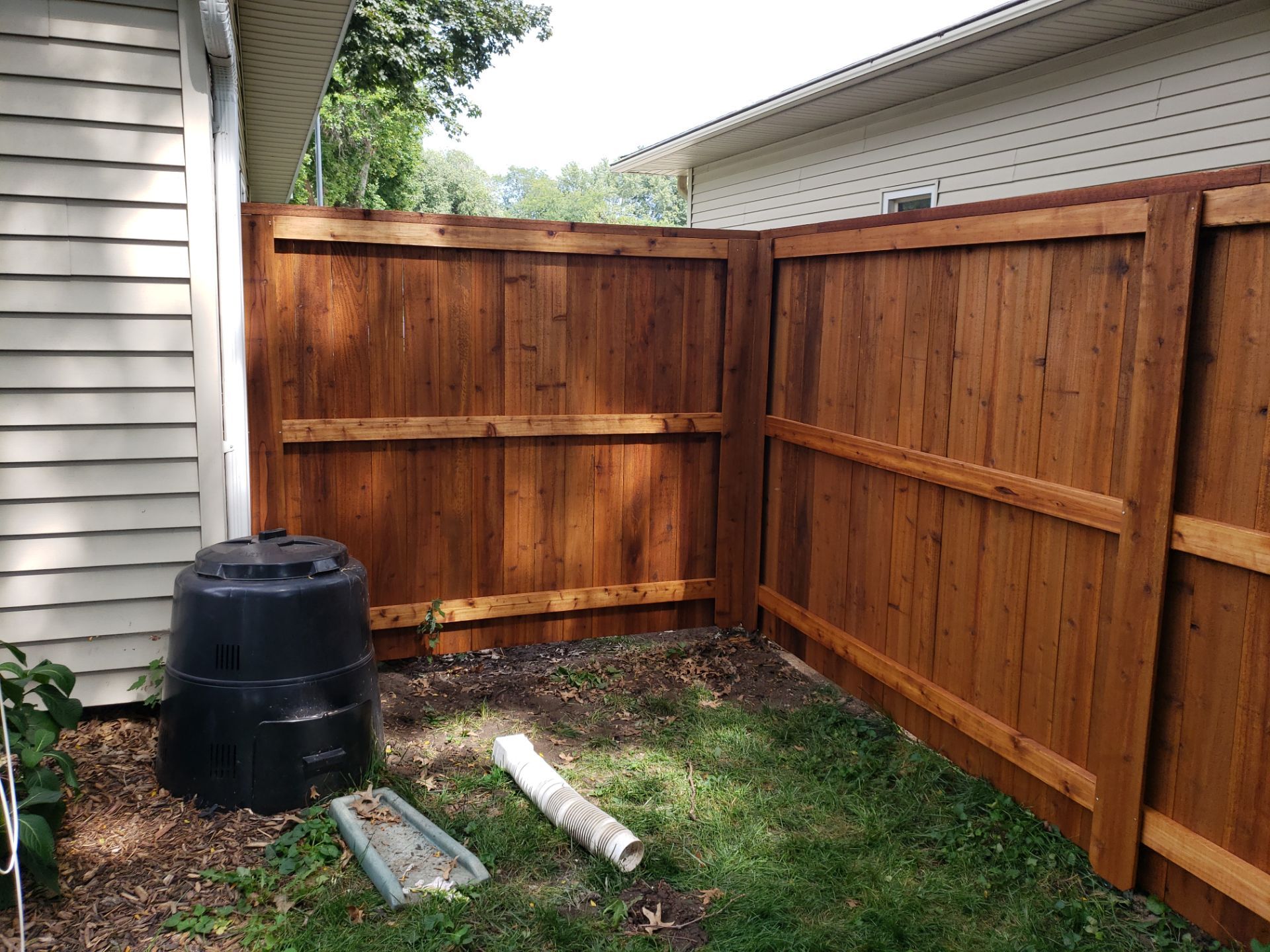 Custom Cedar Privacy Fence with Decorative Gate Windows in Cedar Falls by Perfect Picket Fence and Stain