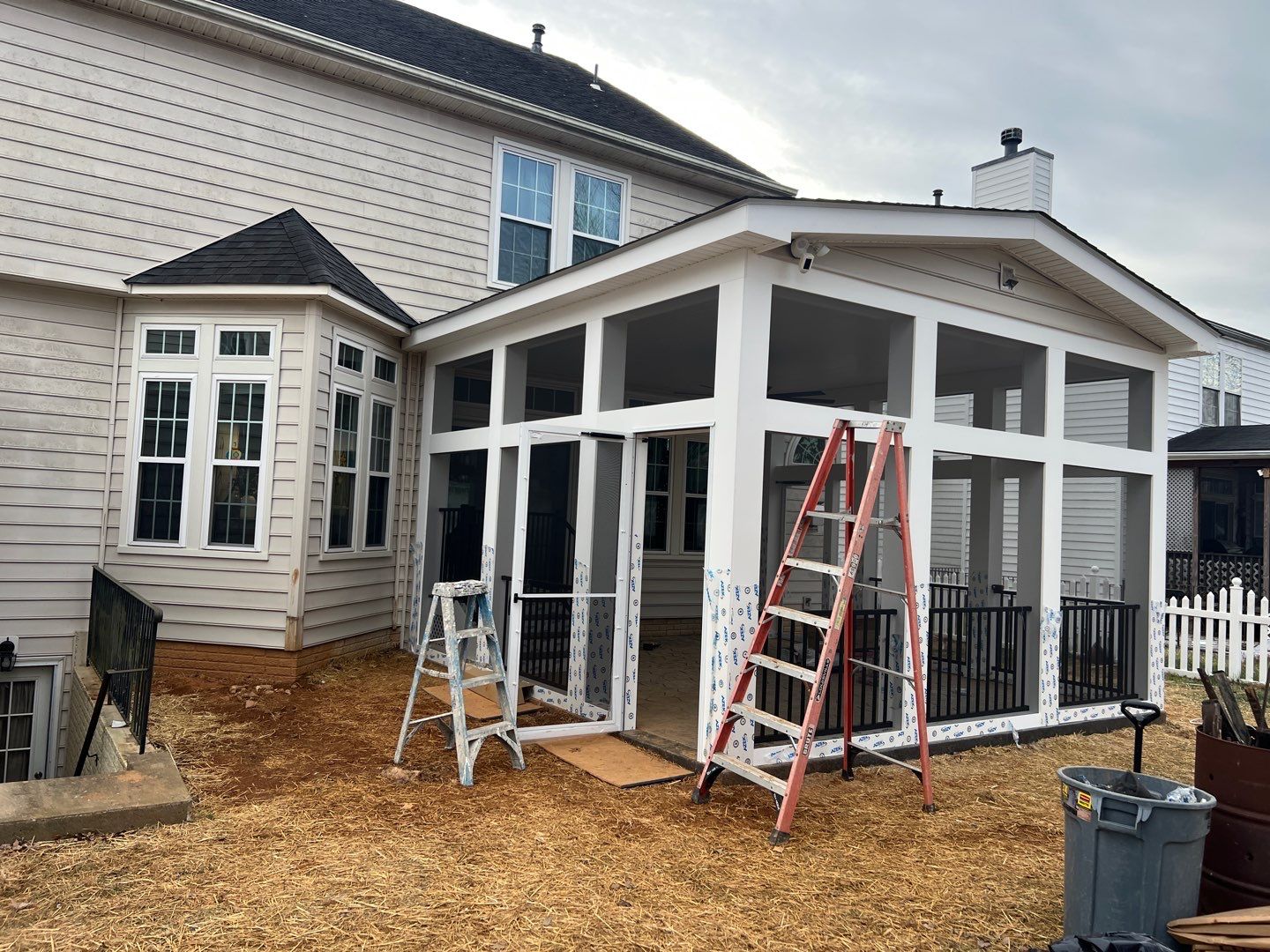 Custom Screened-In Porch with Stamped Concrete Patio in Warrenton by Jakari Restoration & Construction LLC