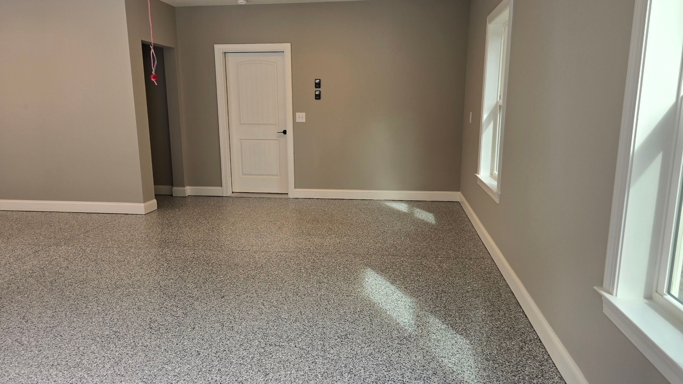 Patio Using Basalt & Garage Using Gravel by Elite Floor Solutions