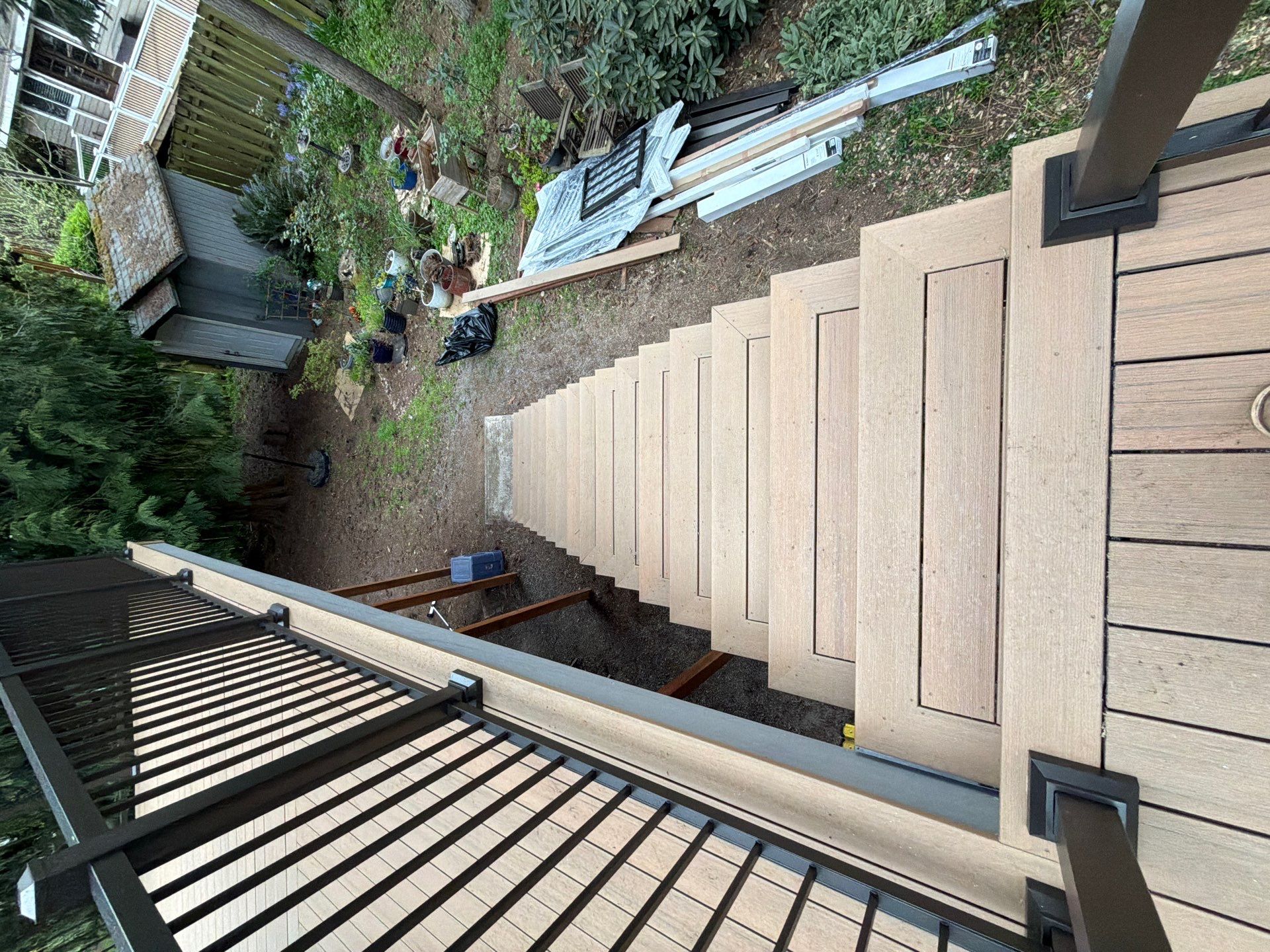 Elevated TimberTech Composite Deck Replacement With Black Metal Railings by Emerald City Energy