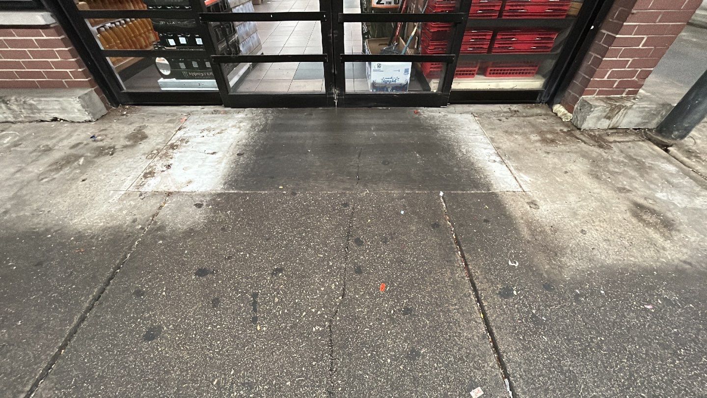 Concrete sidewalk cleaning and degreasing by Northern Power Washing LLC.