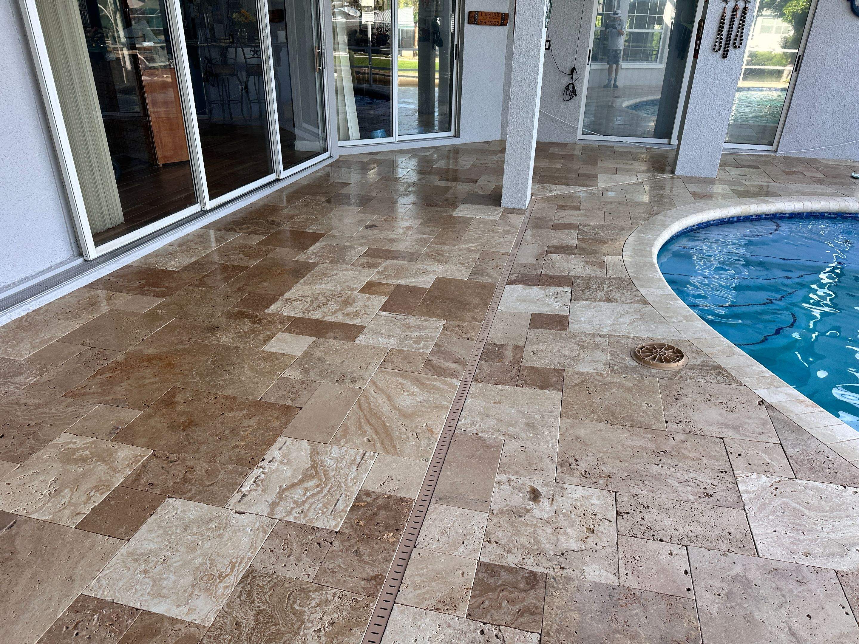 Travertine Sealing and Stripping for a Waterfront Pool Deck in Apollo Beach by Supreme Paver Experts