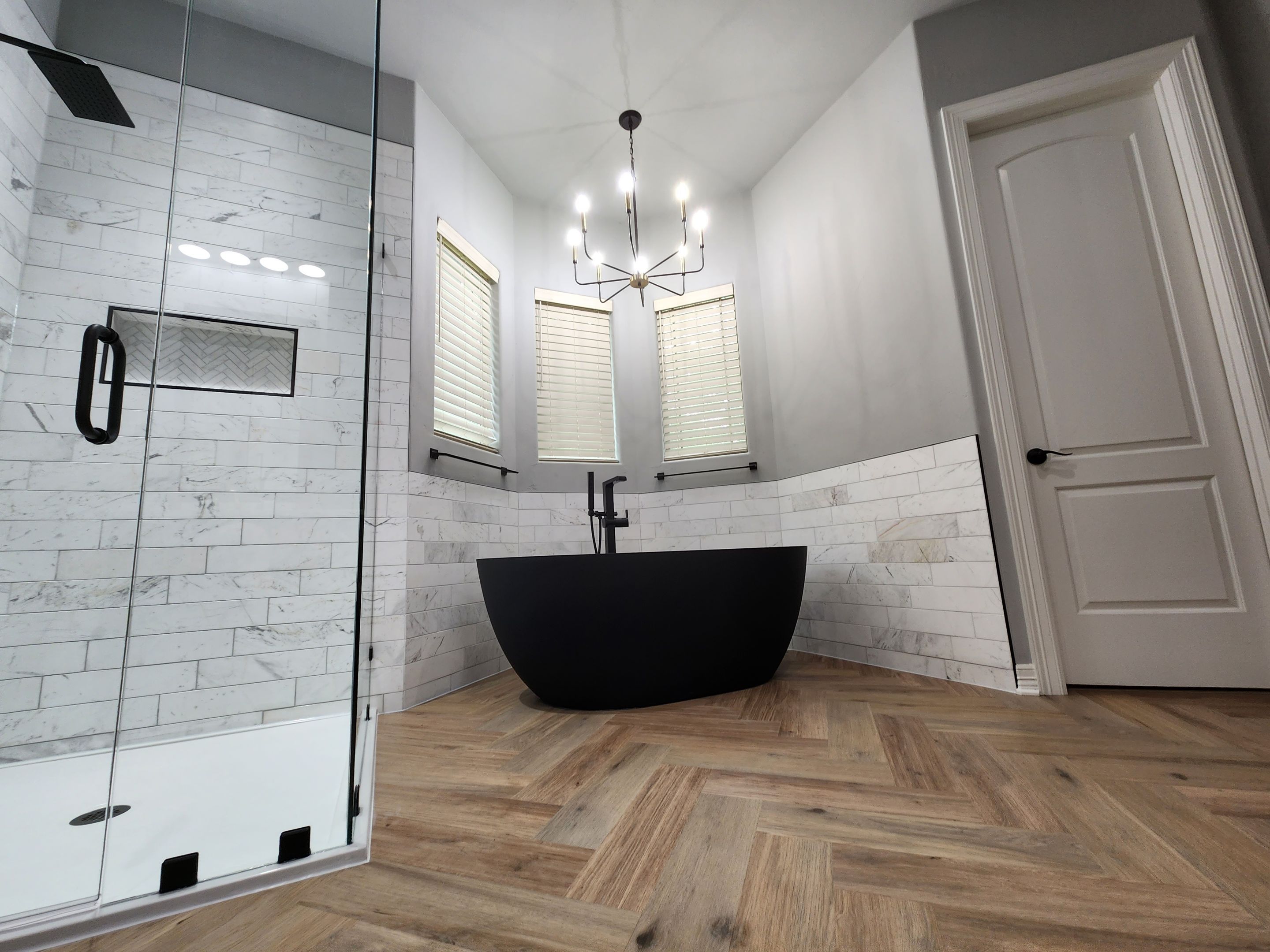 Spring Bathroom Remodel with Black Free-Standing Tub and Walk-In Shower by Legacy Bath and Kitchen