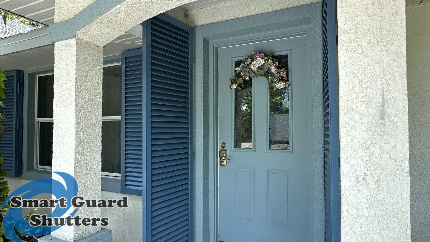 Impact Rated Colonial Shutters in Pigeon Blue by Smart Guard Shutters