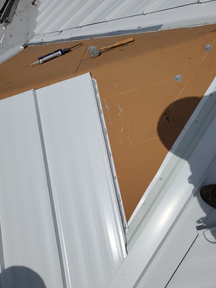 Residential Roofing Installation using 1.5" Nail Strip 24ga Solar White Kynar Coated Standing Seam Metal Panels by Morton Roofing, Inc.