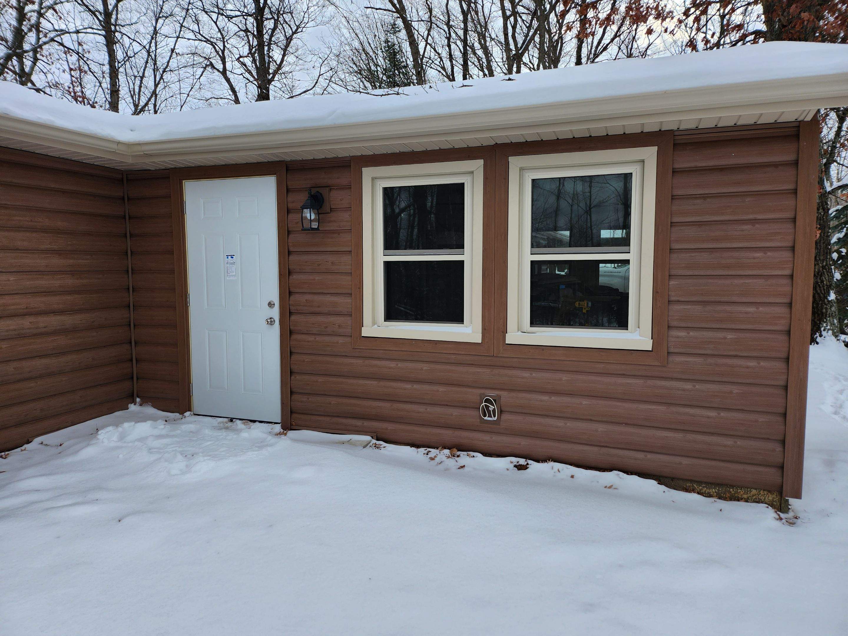 New addition and log siding by Energy Plus Home Improvements