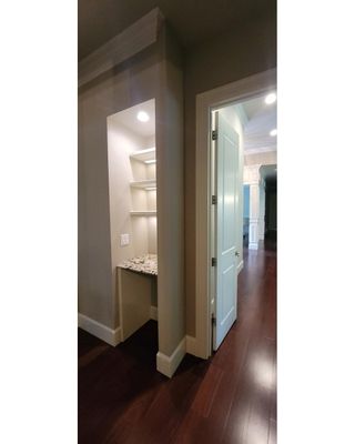 Closet transformation to coffee nook with custom shelves and LED lighting.