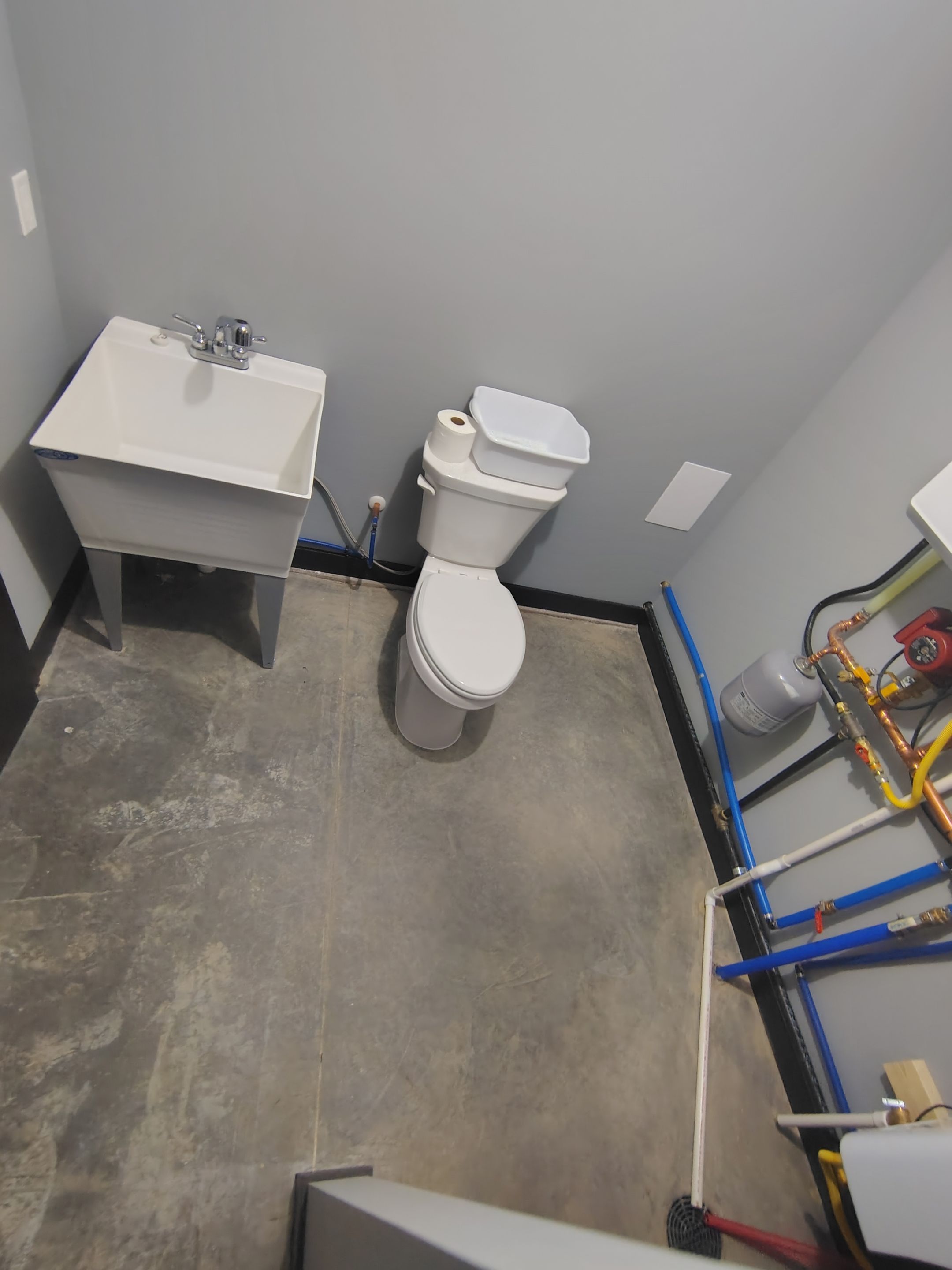 Polyaspartic Garage Floor Coating with Decorative Flake in Wentworth by Select Painting, Coatings & Garage Cabinets