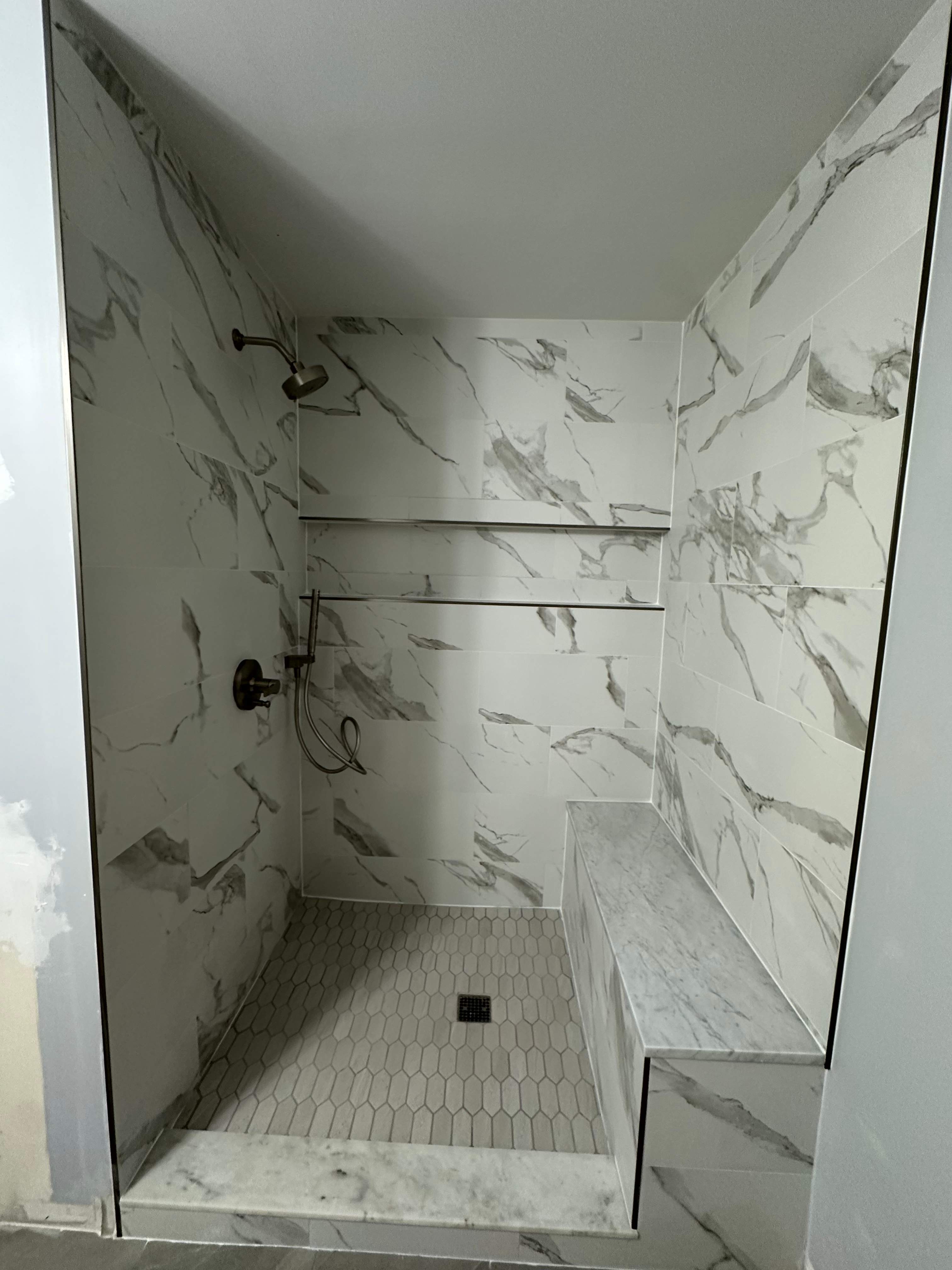 Tub to walk-in shower conversion, and tile flooring by Prudencio
