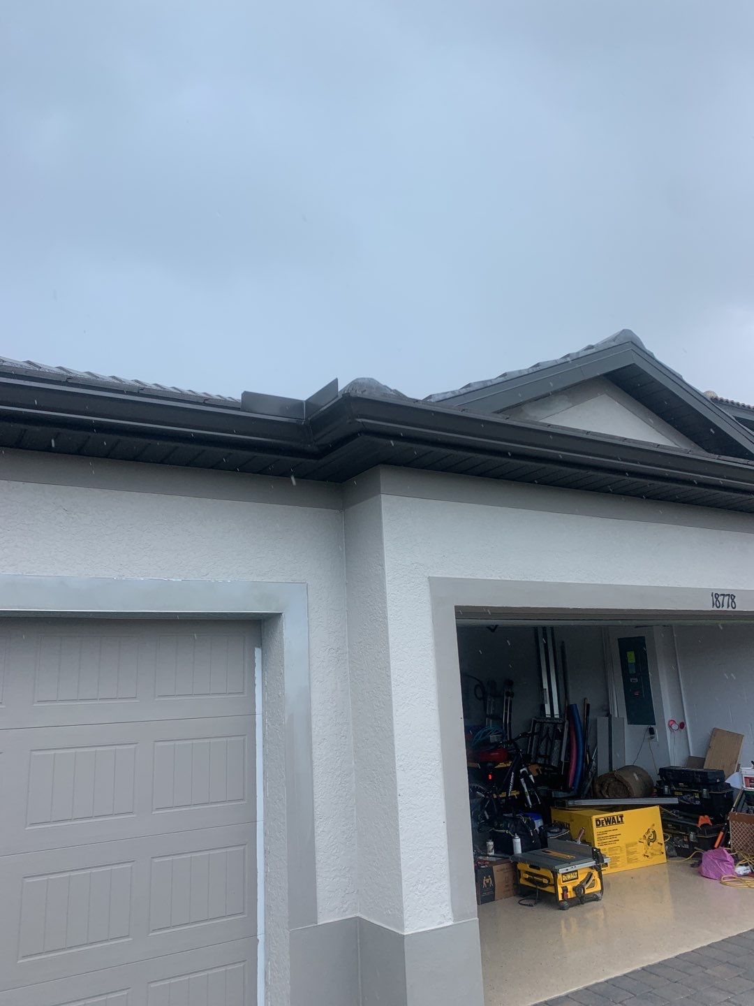 Seamless brown gutter and downspouts installation in Estero, FL  by Gutter Professors