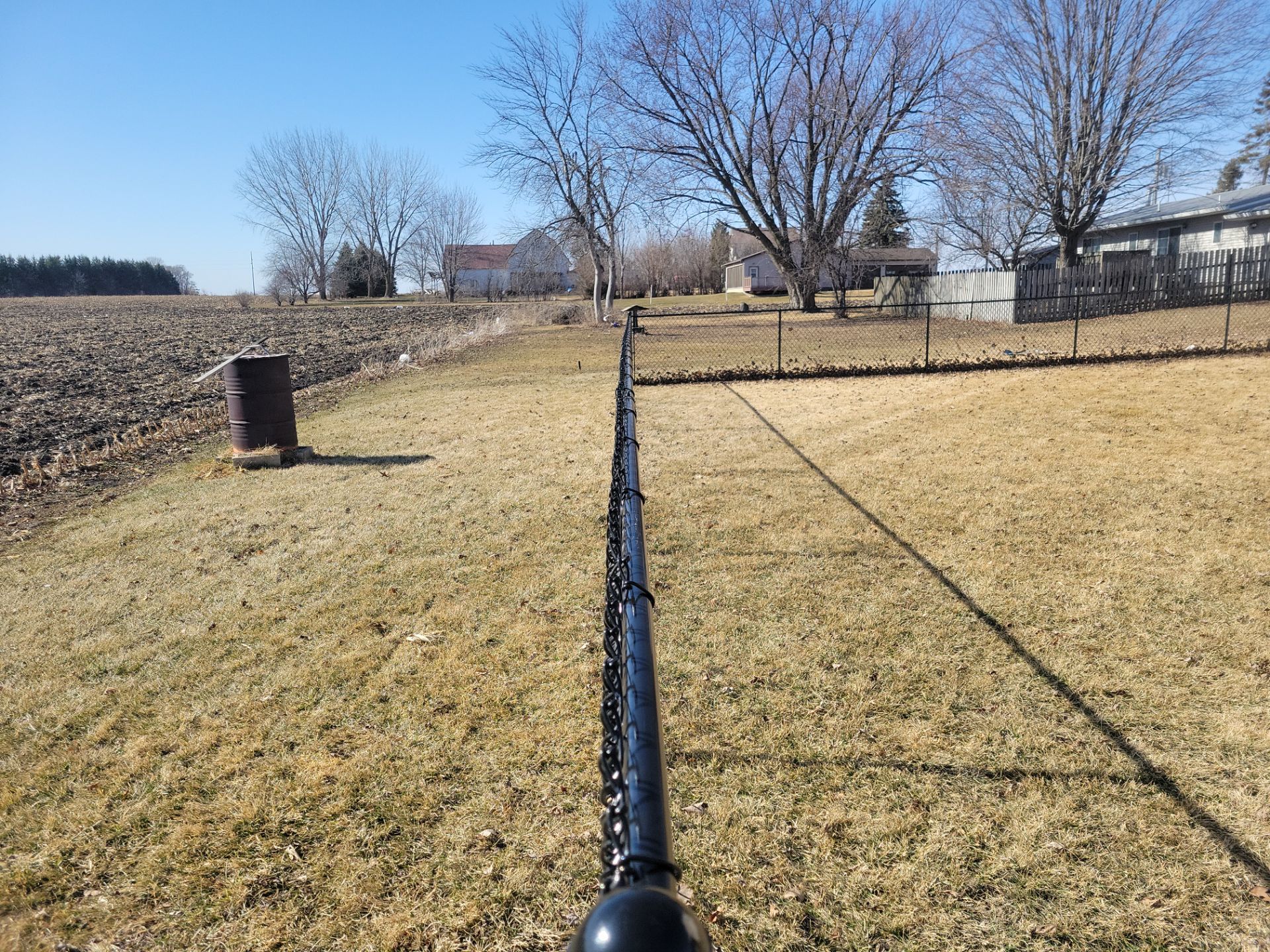 Residential Black Chain Link Fence and Gate Installation in Tripoli by Perfect Picket Fence and Stain