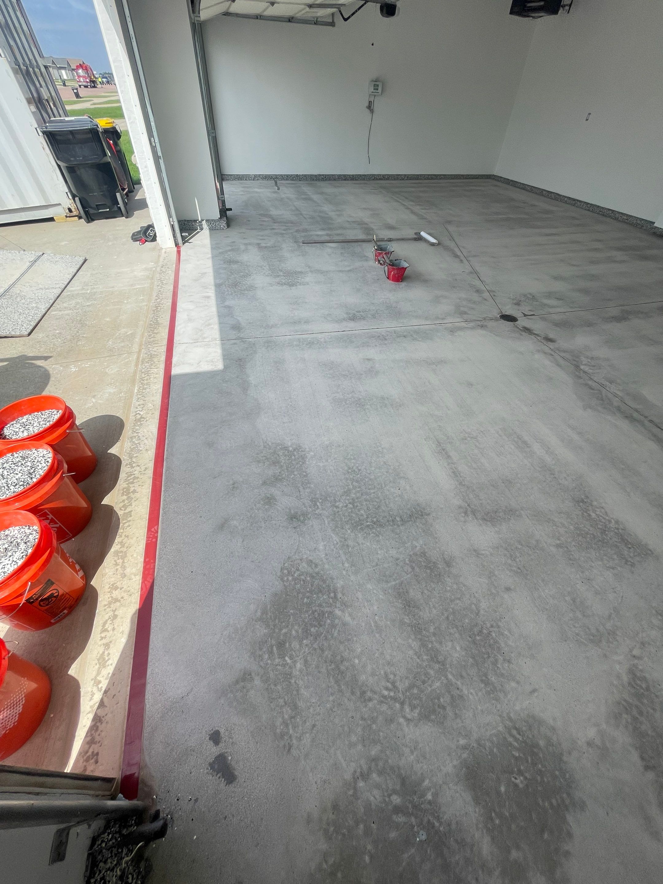 Grey Flake Epoxy Garage Floor Coating in Sioux Falls by Select Painting, Coatings & Garage Cabinets