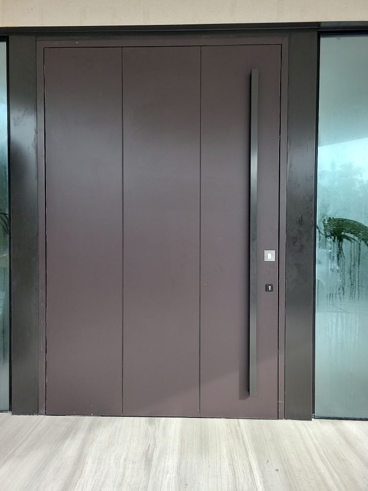 Custom Material Pivot Door installation by Impact Precious Wood Inc.